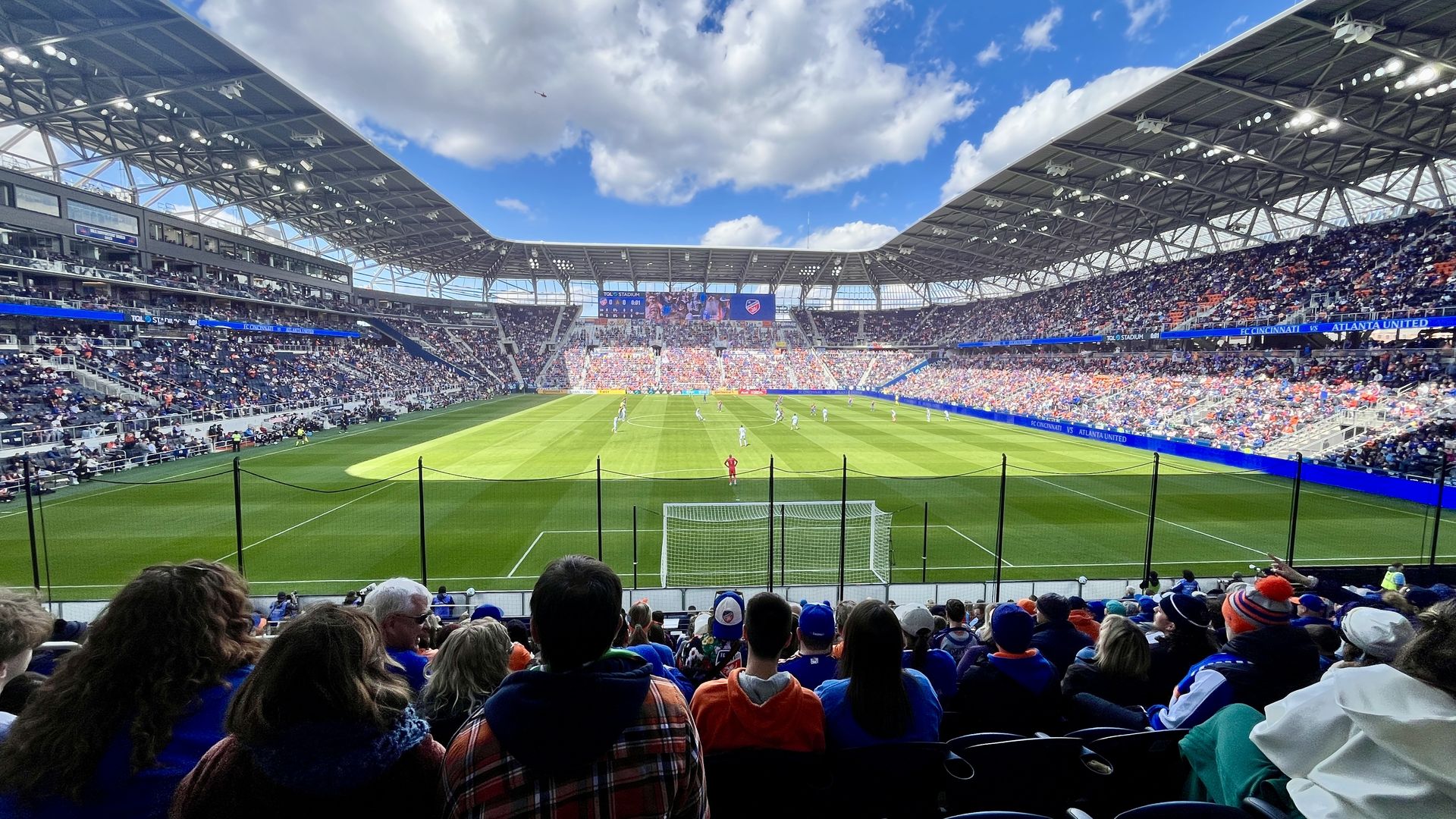 Fans watch an FC Cincinnati home match at TQL Stadium in Cincinnati. It's a sunny day and the crowd is mostly full.
