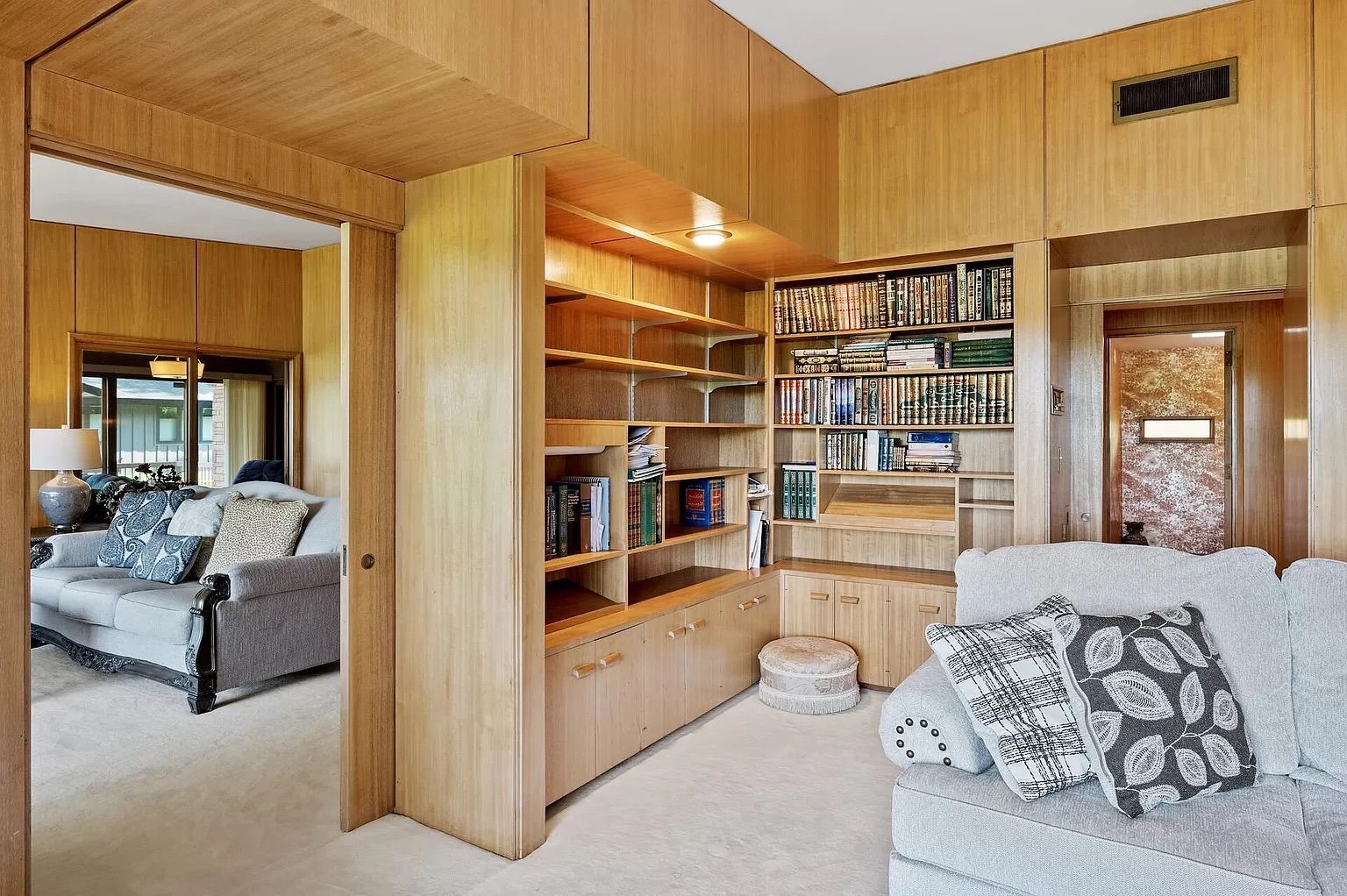The living room with built-in bookshelves.