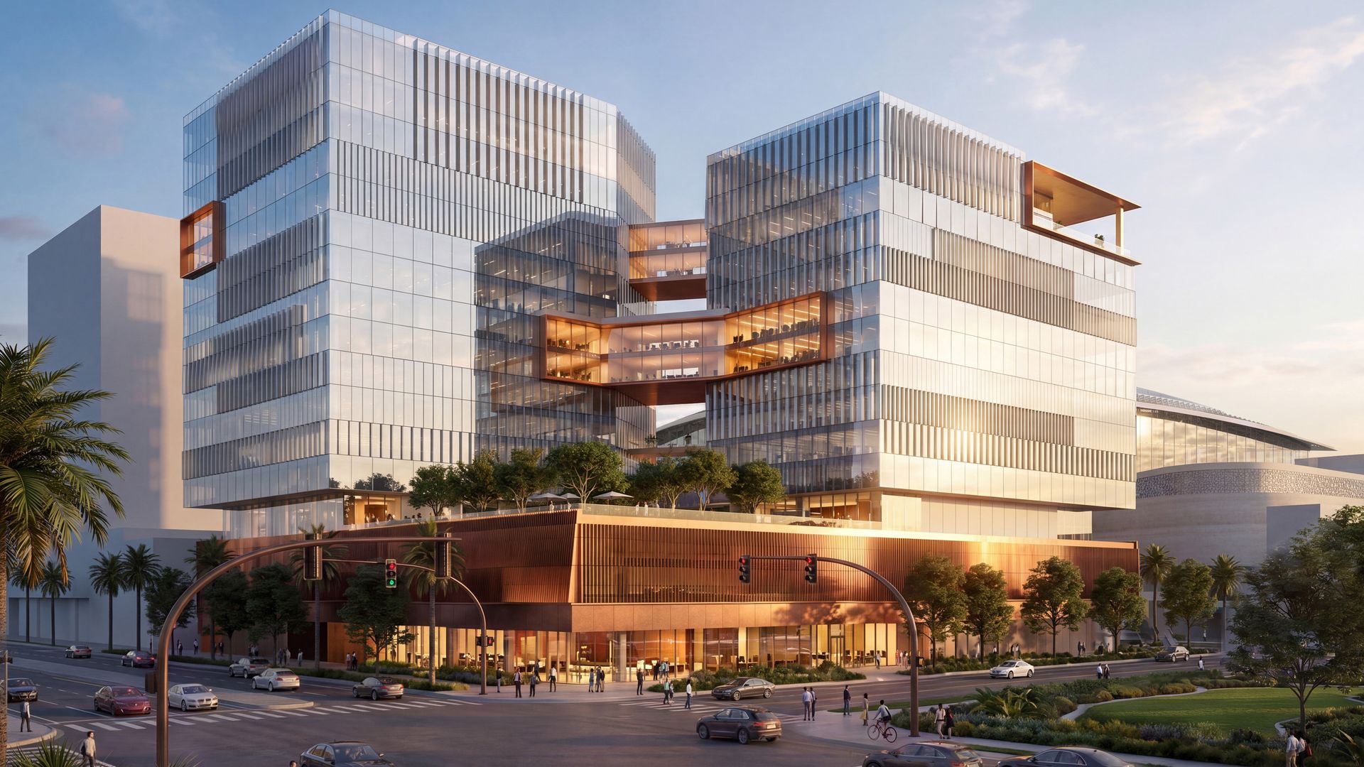 Modern glass office complex with two stacked towers connected by skybridges, reflecting the blue sky and warm copper accents. Ground level shows cars, pedestrians, cyclists, and trees along a street.