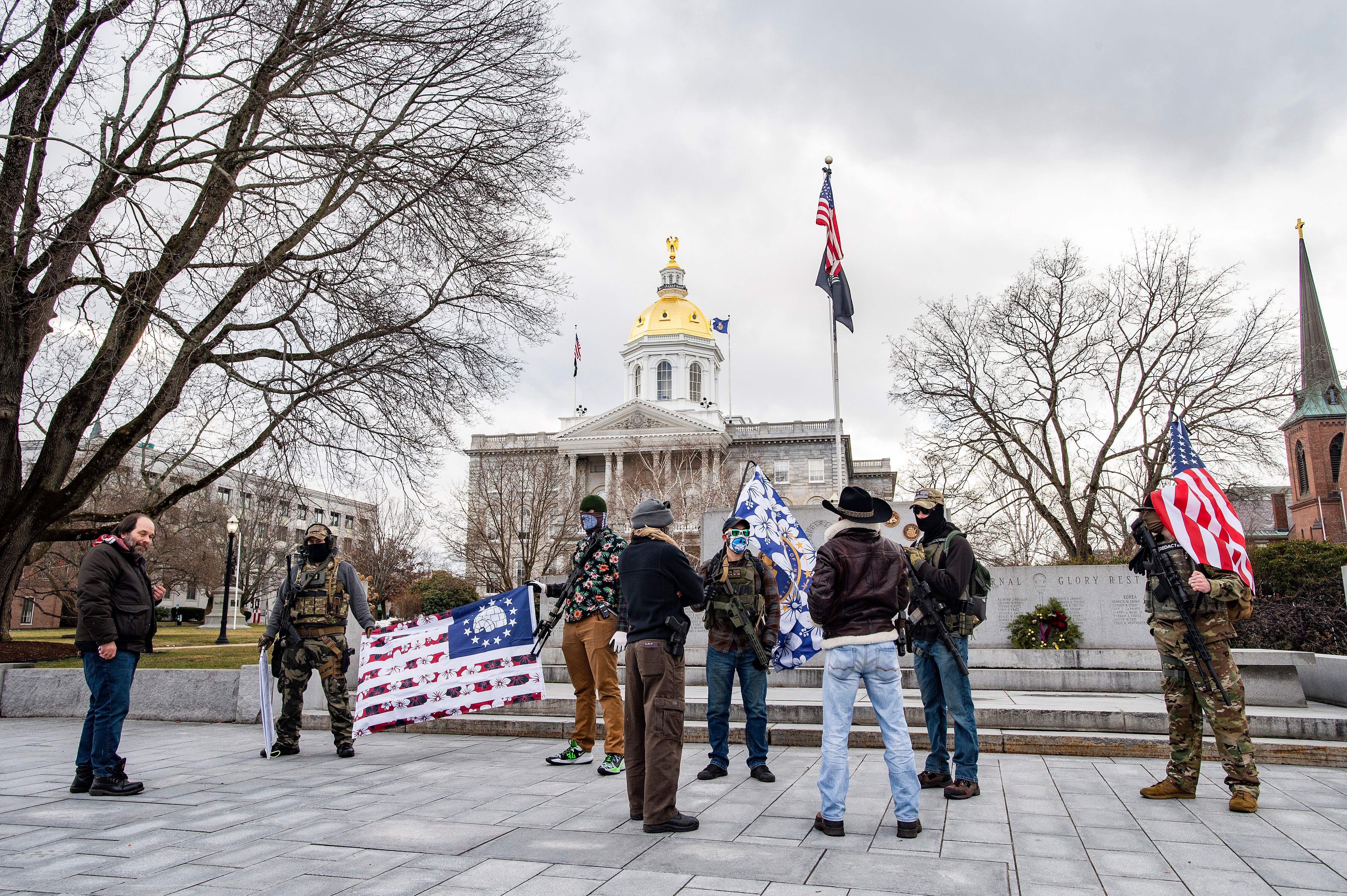 Armed members of the Boogaloo militia speak to people in front of the State Capital in Concord, New Hampshire on January 17