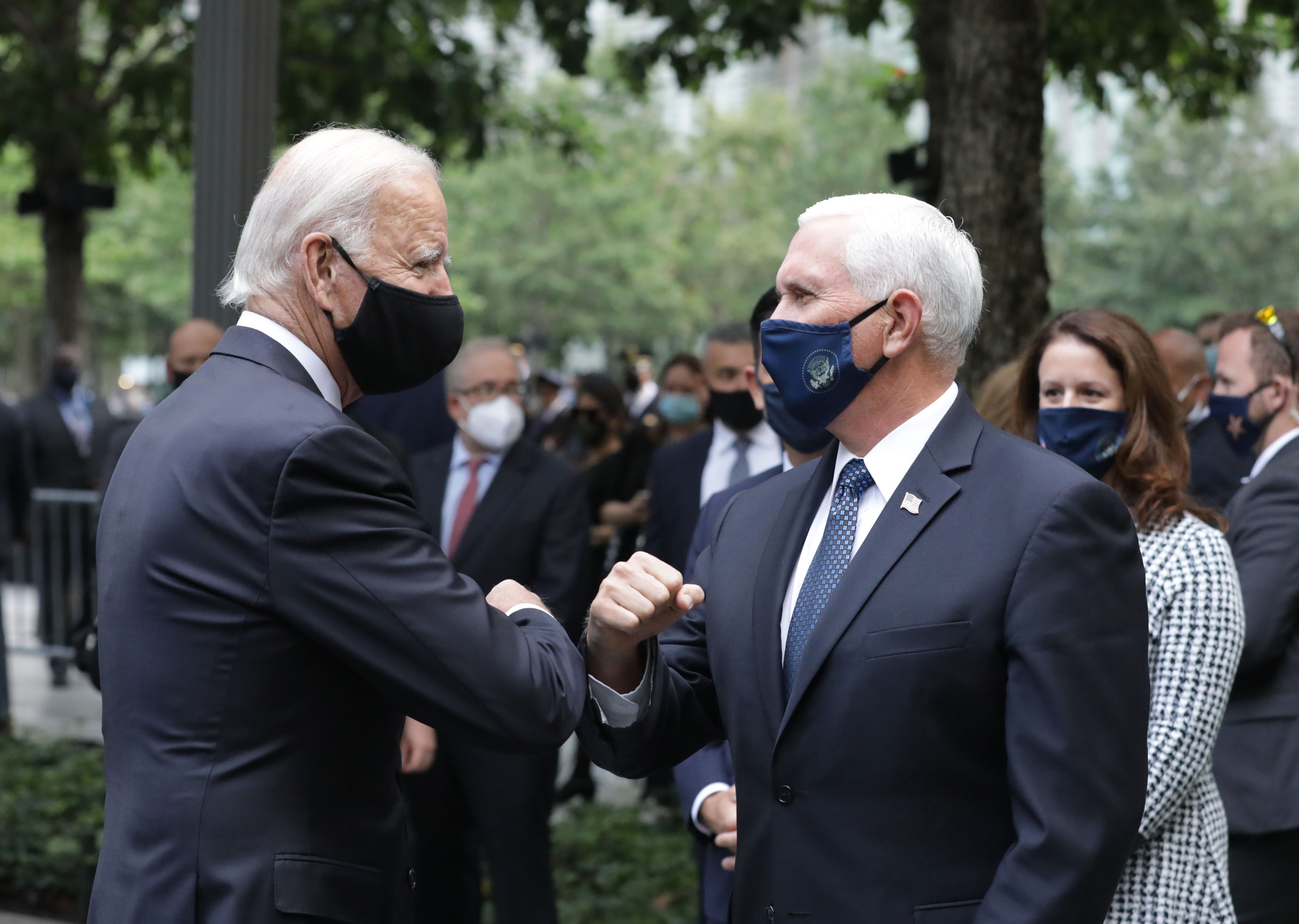 Vice presidents Mike Pence and Joe Biden bump elbows at a ceremony at the 9/11 Memorial in New York City.