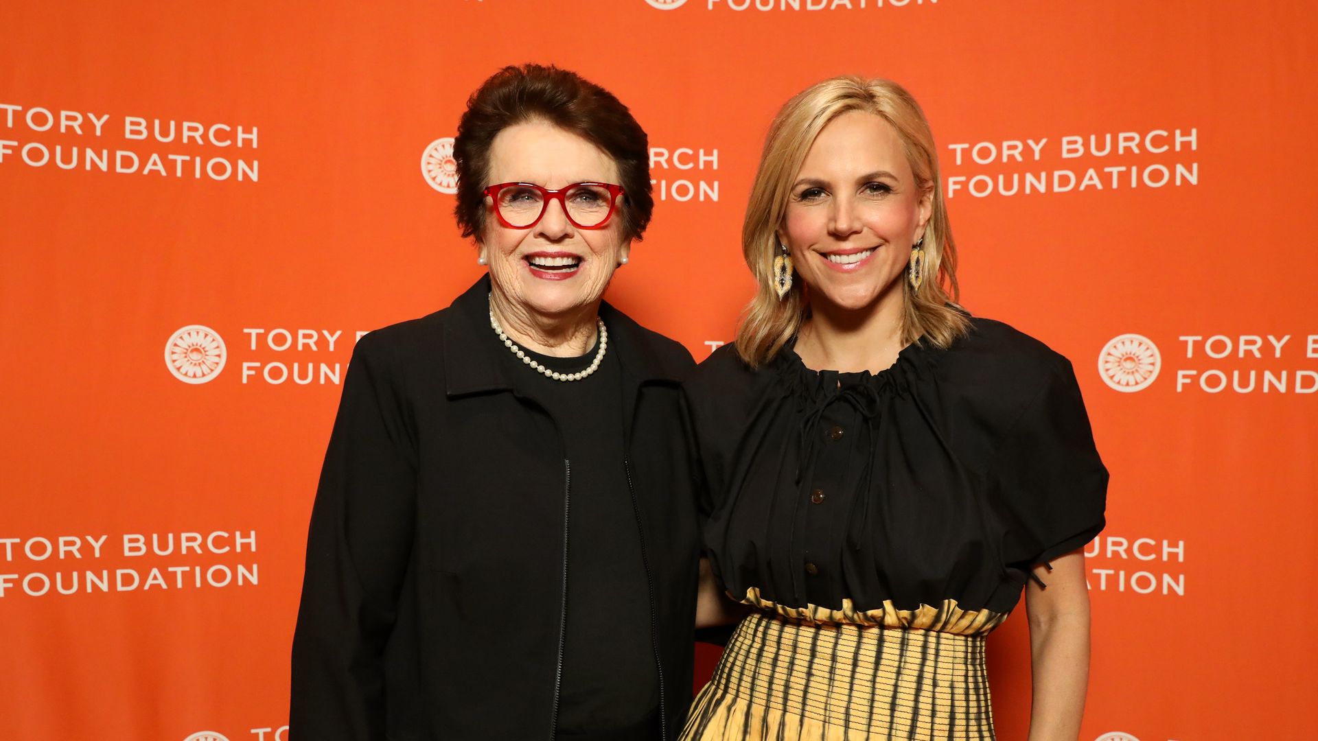 Former tennis champion Billie Jean King and entrepreneur Tory Burch pose for the camera.