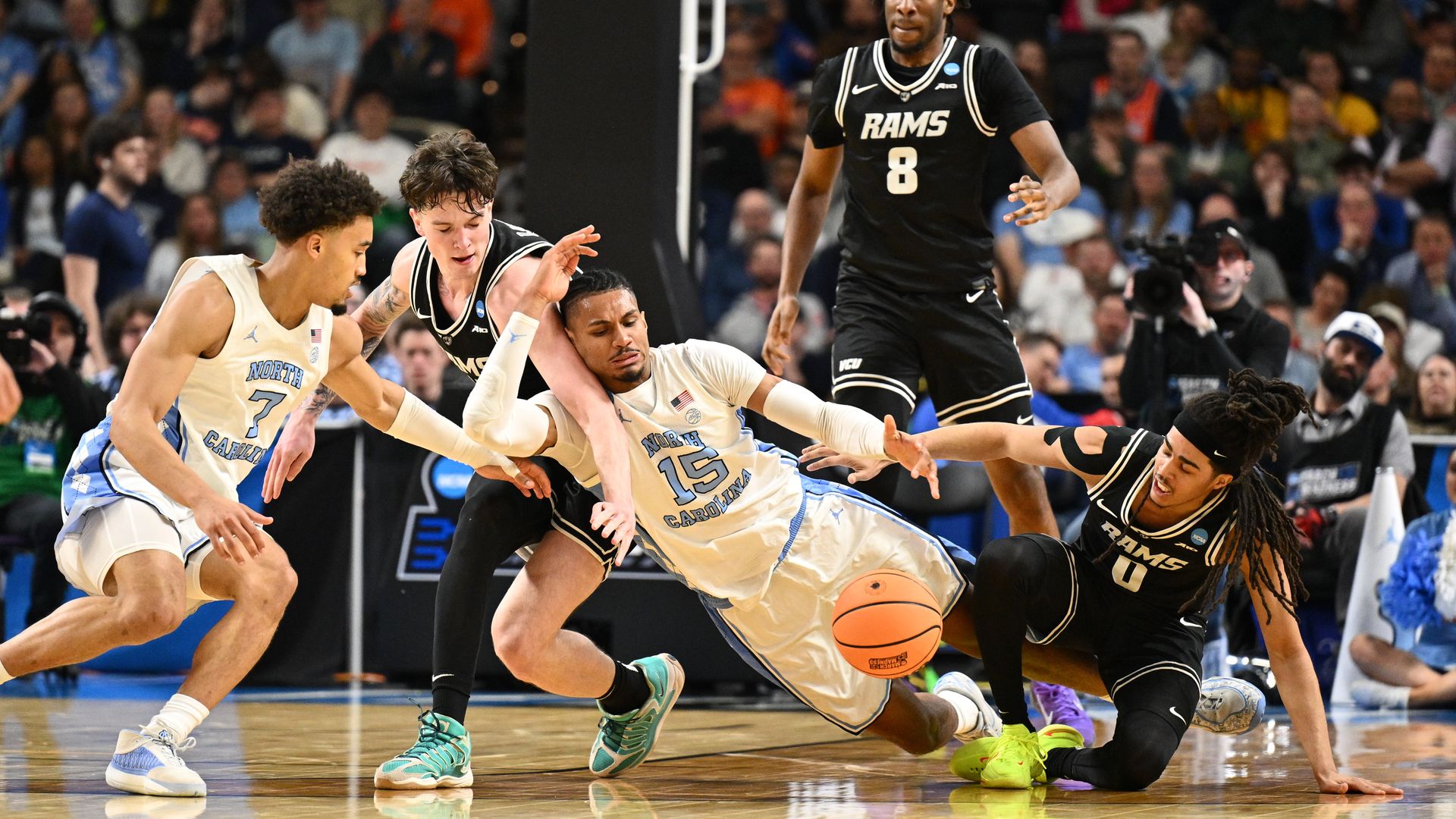 GREENVILLE, SOUTH CAROLINA - MARCH 19: Jarin Stevenson #15 and Seth Trimble #7 of the North Carolina Tar Heels go for a loose ball with Lazar Djokovic #17 and Brandon Jennings #0 of the VCU Rams during the first round of the 2026 NCAA Men's Basketball Tournament held at Bon Secours Wellness Arena on