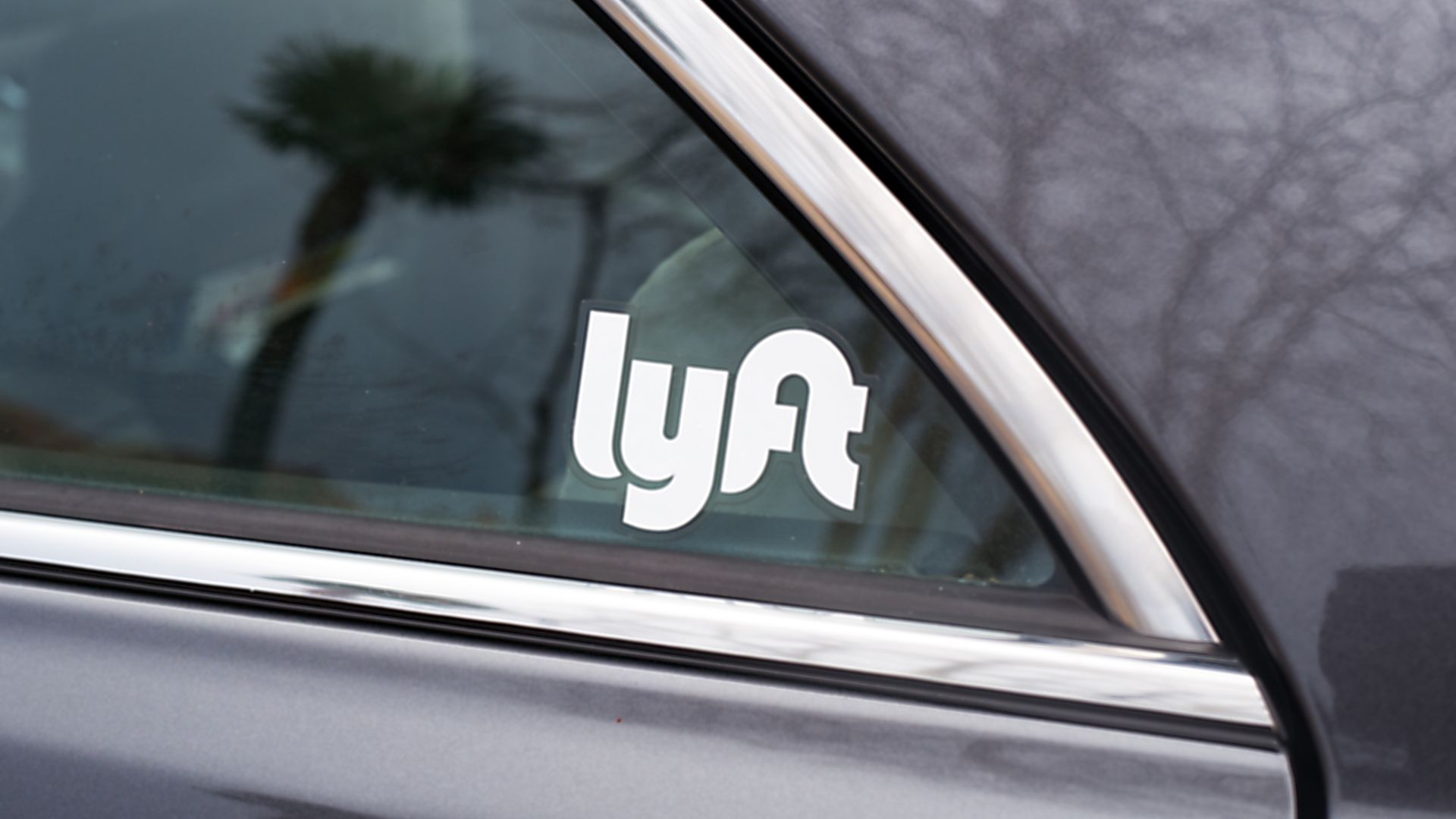 A car with a Lyft sticker on the window.