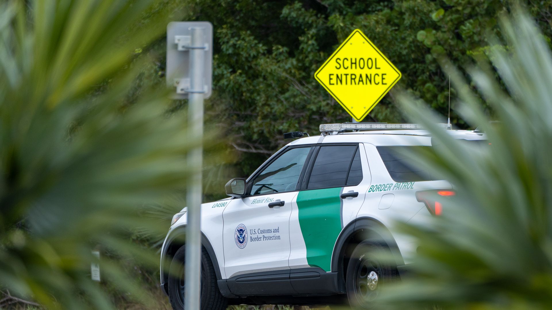 BIG PINE KEY, UNITED STATES - 2025/12/09: A U.S. Customs and Border Protection vehicle patrols the Overseas Highway near the entrance of a school. (Photo by Jen Golbeck/SOPA Images/LightRocket via Getty Images)