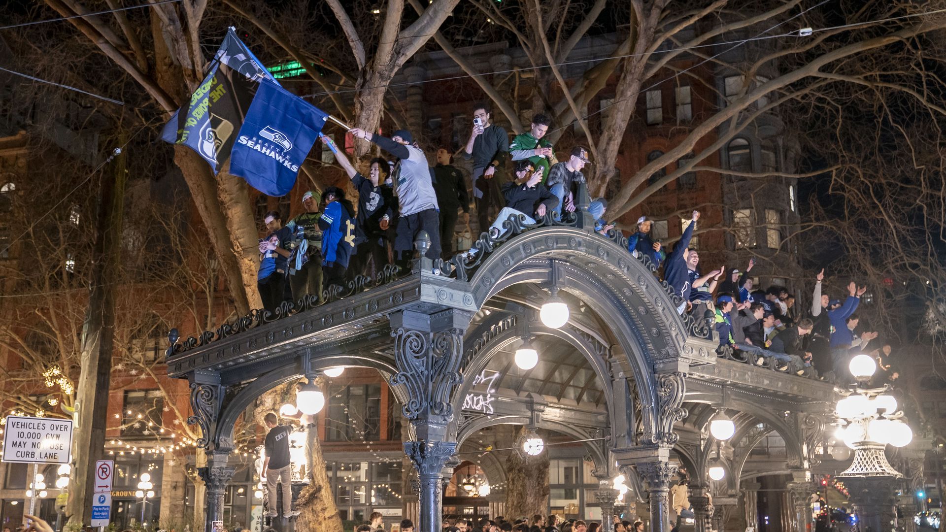 Seattle Seahawks fans celebrate atop a historic pergola in the Pioneer Square neighborhood after their team won Super Bowl LX on February 8.