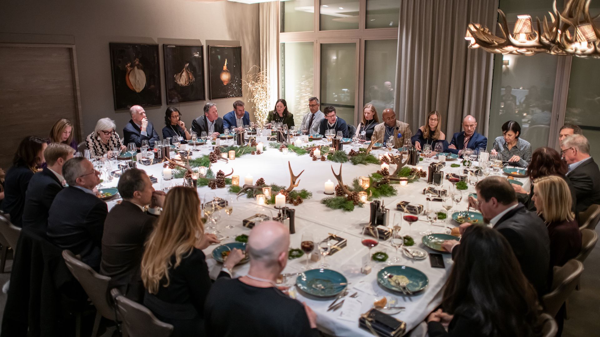 Table of participants sits conversing during the event. 