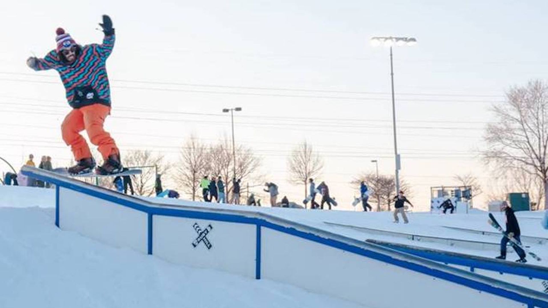 A snowboarder grinds a down-flat-down rail at Ruby Hill. Photo courtesy of Denver Parks & Recreation