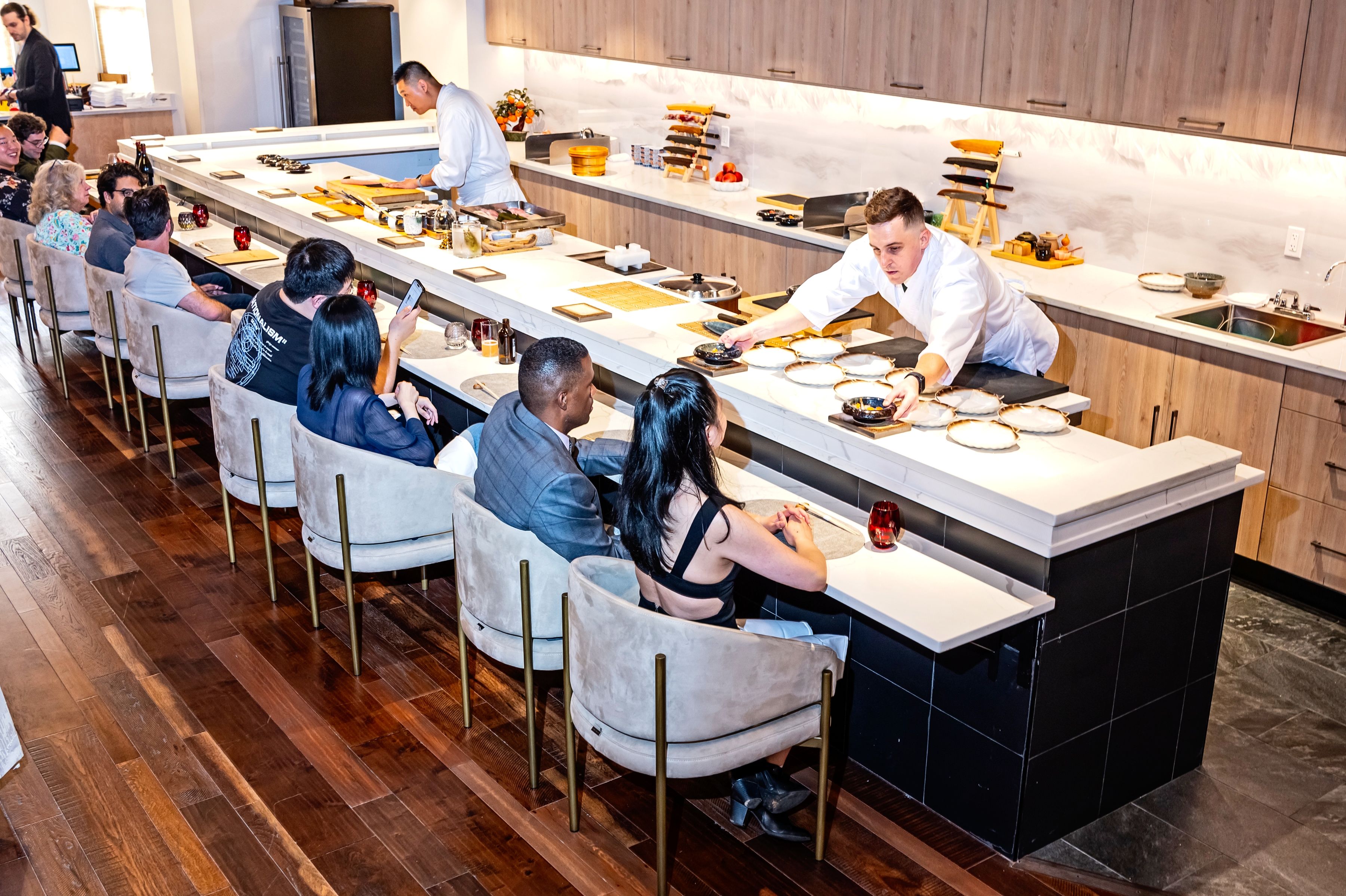 Chef Ricky Wang, left, and Chef Apprentice Michael Blankenship behind the counter at Omakase at Barracks Row Restaurant photographed June 26, 2024 in Washington, DC. (Photo by Scott Suchman for The Washington Post via Getty Images)
