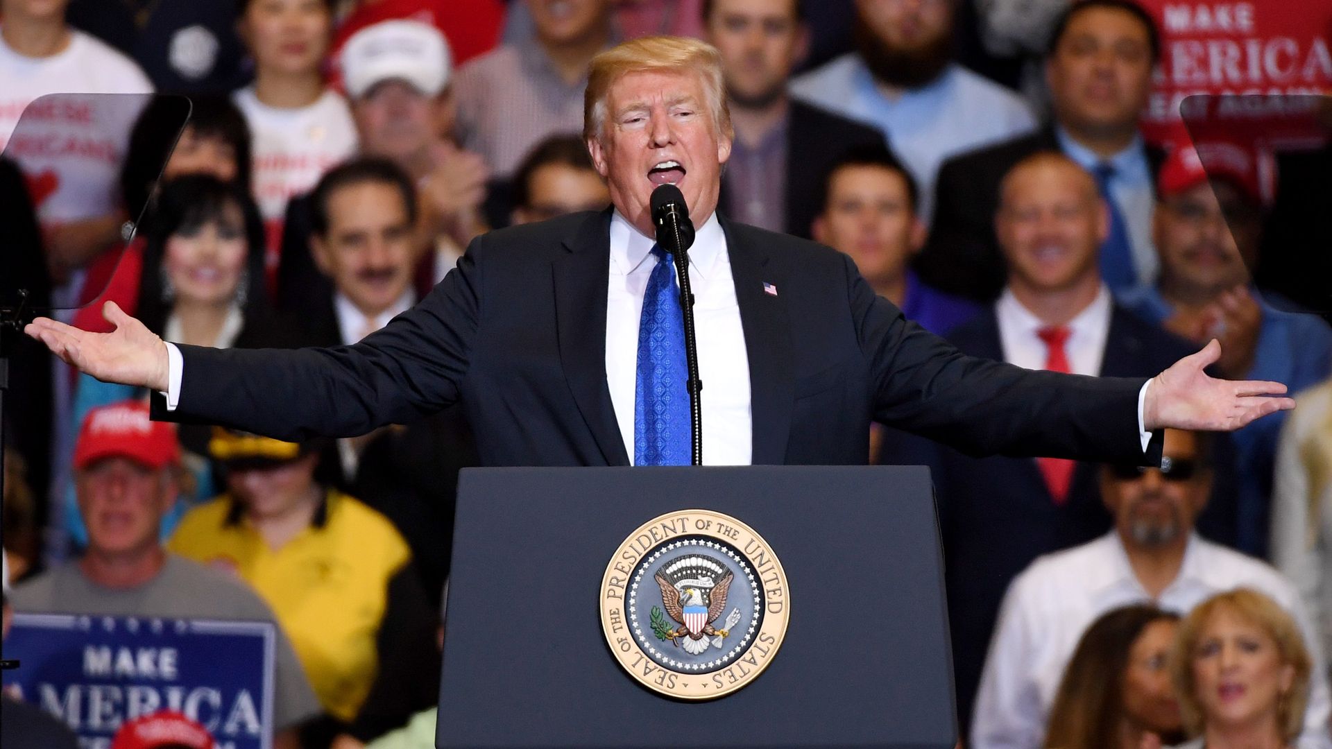 President Trump throws his hands in the air while speaking at a rally in Las Vegas