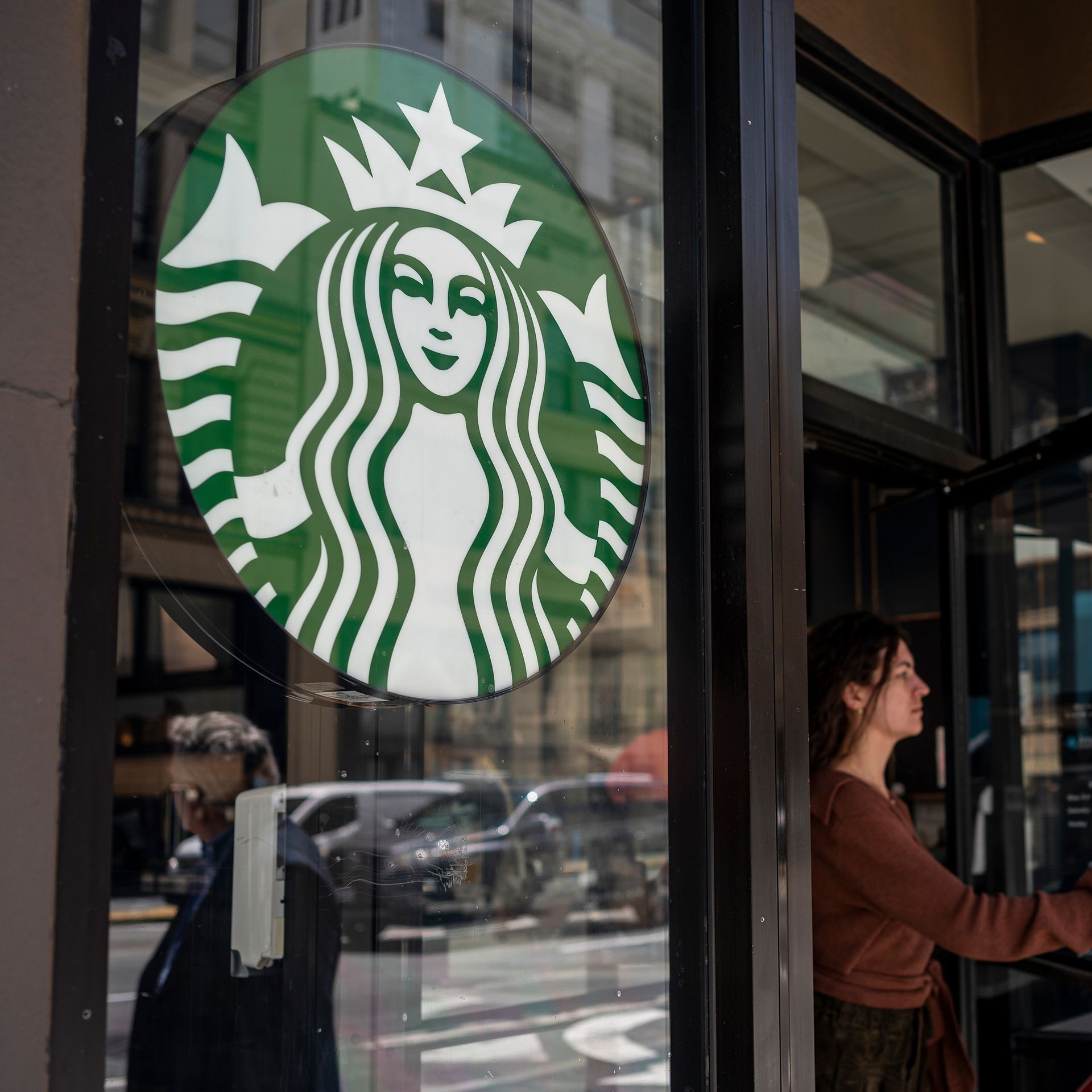 Starbucks store with woman walking through door