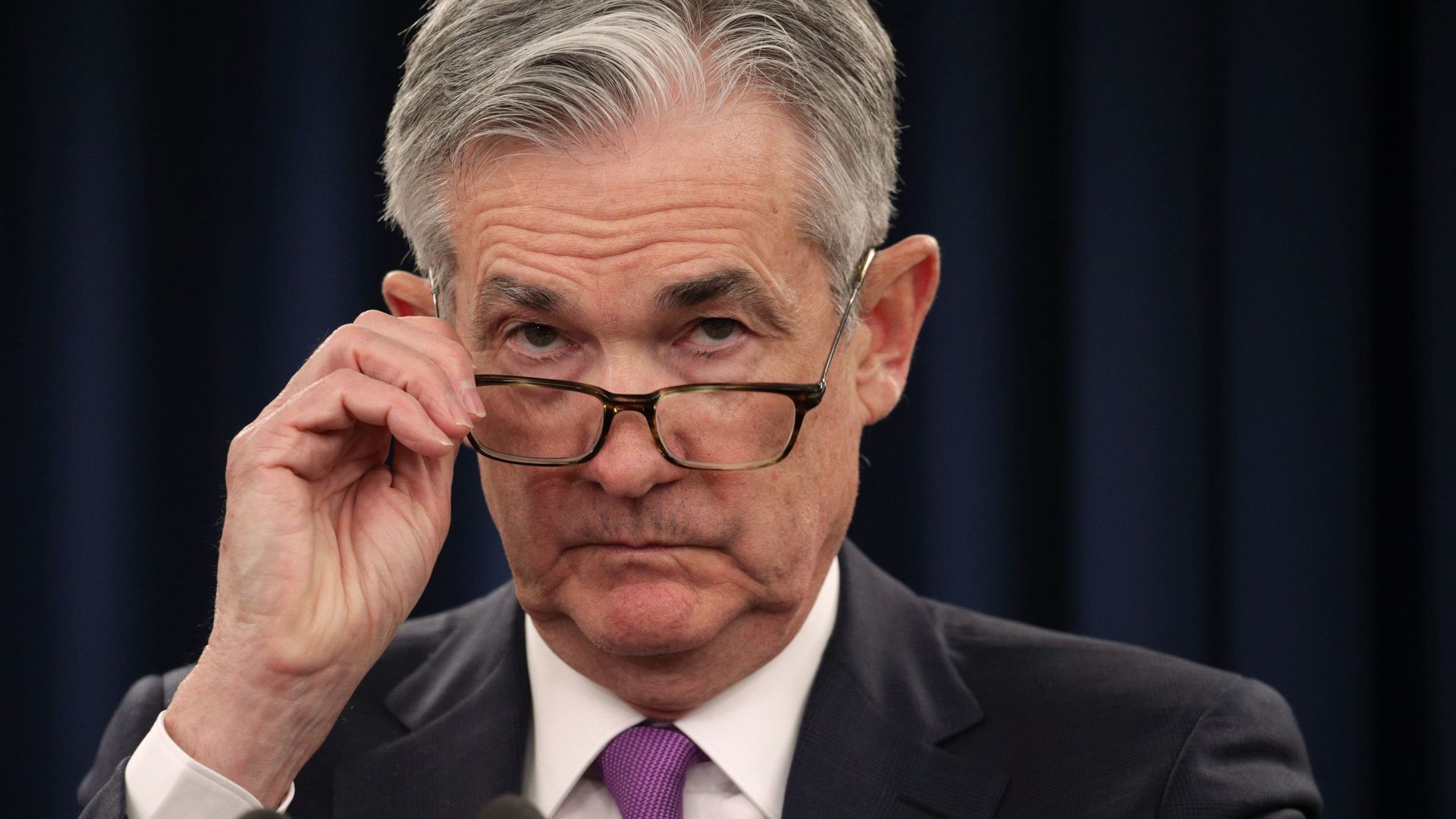 Federal Reserve Board Chairman Jerome Powell peers over his glasses during a news conference