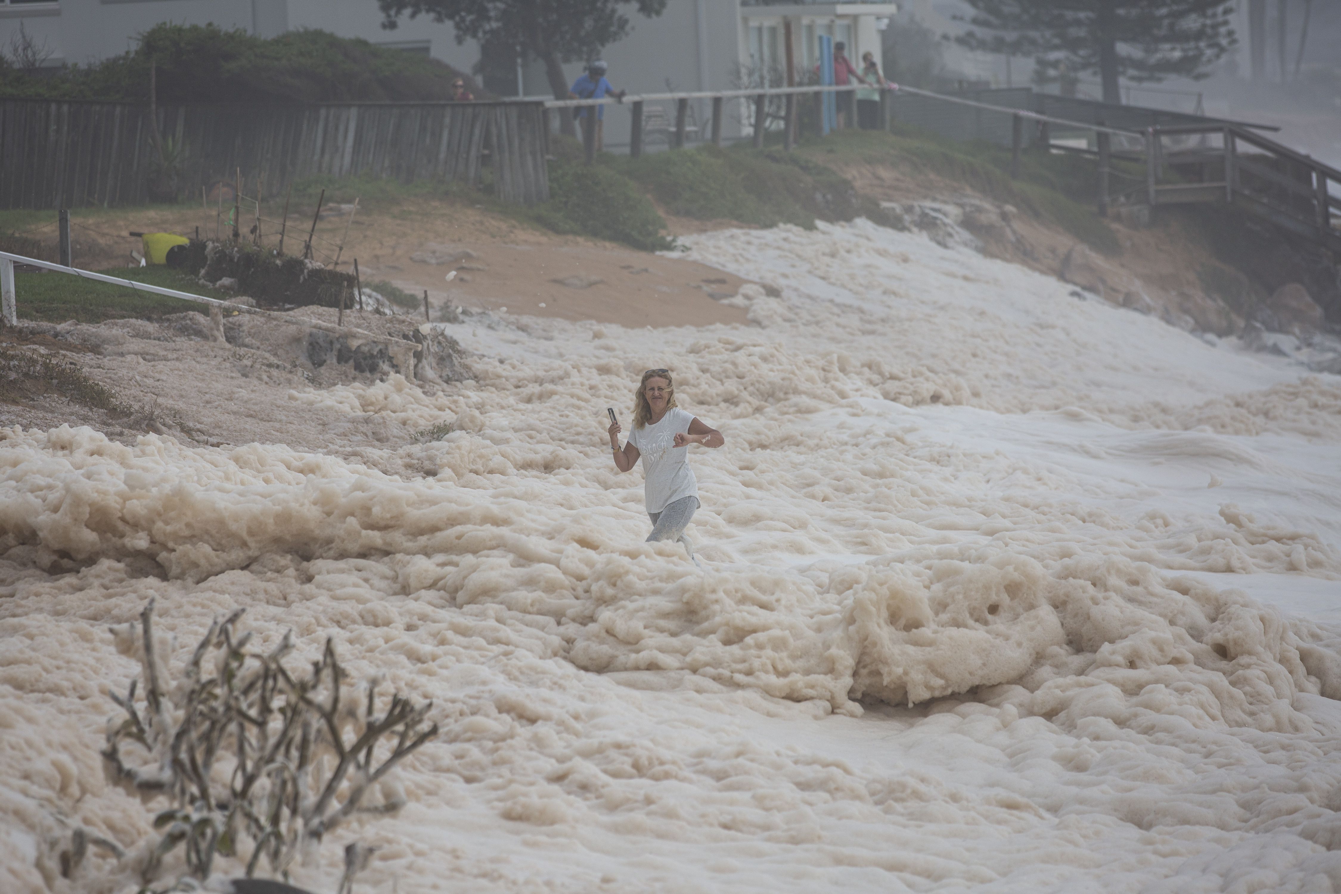 A Collaroy resident watches on at Collaroy on the Northern Beaches as a high tide and large waves impact the coast on February 10, 2020 in Sydney