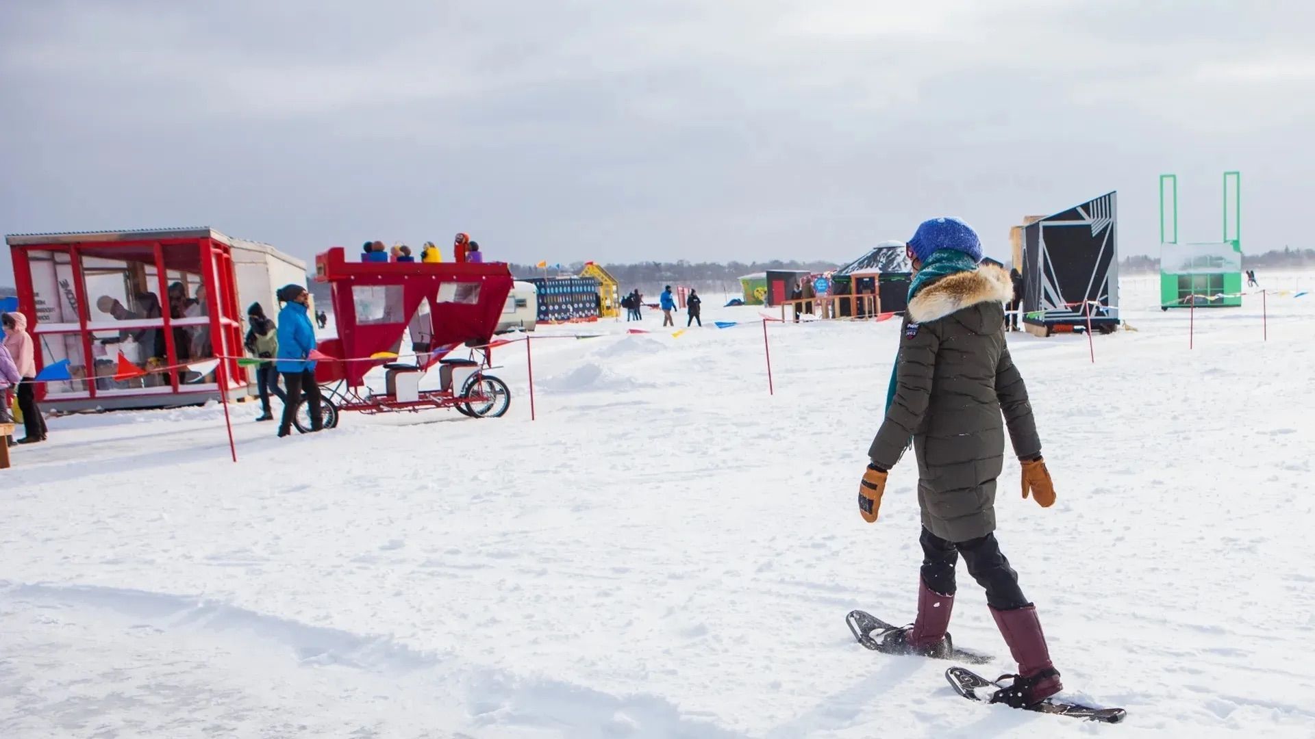 A photo of a woman on skiis walking across ice.