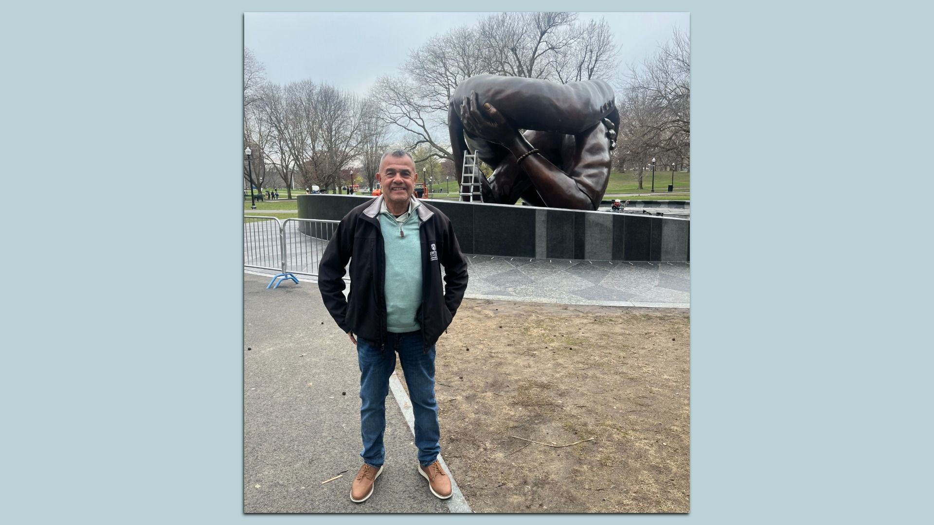 Wayne Lucas, a lifelong Bostonian who marched in the 1965 Freedom Rally and plans to march again, stands in front of the Embrace monument on Boston Common.
