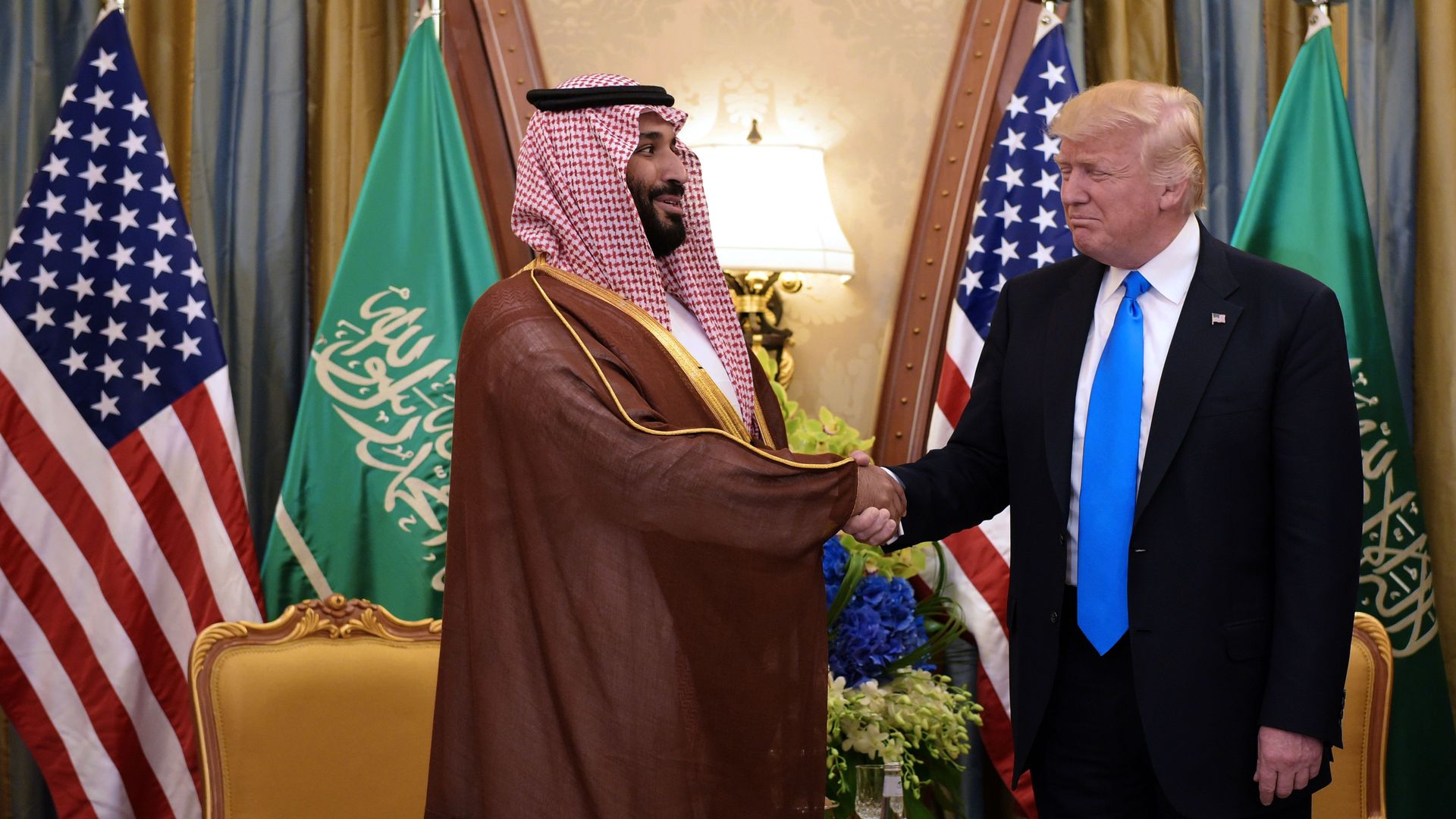 In this image, Trump and the Crown Prince of Saudi Arabia shake hands in an Oval Office meeting.