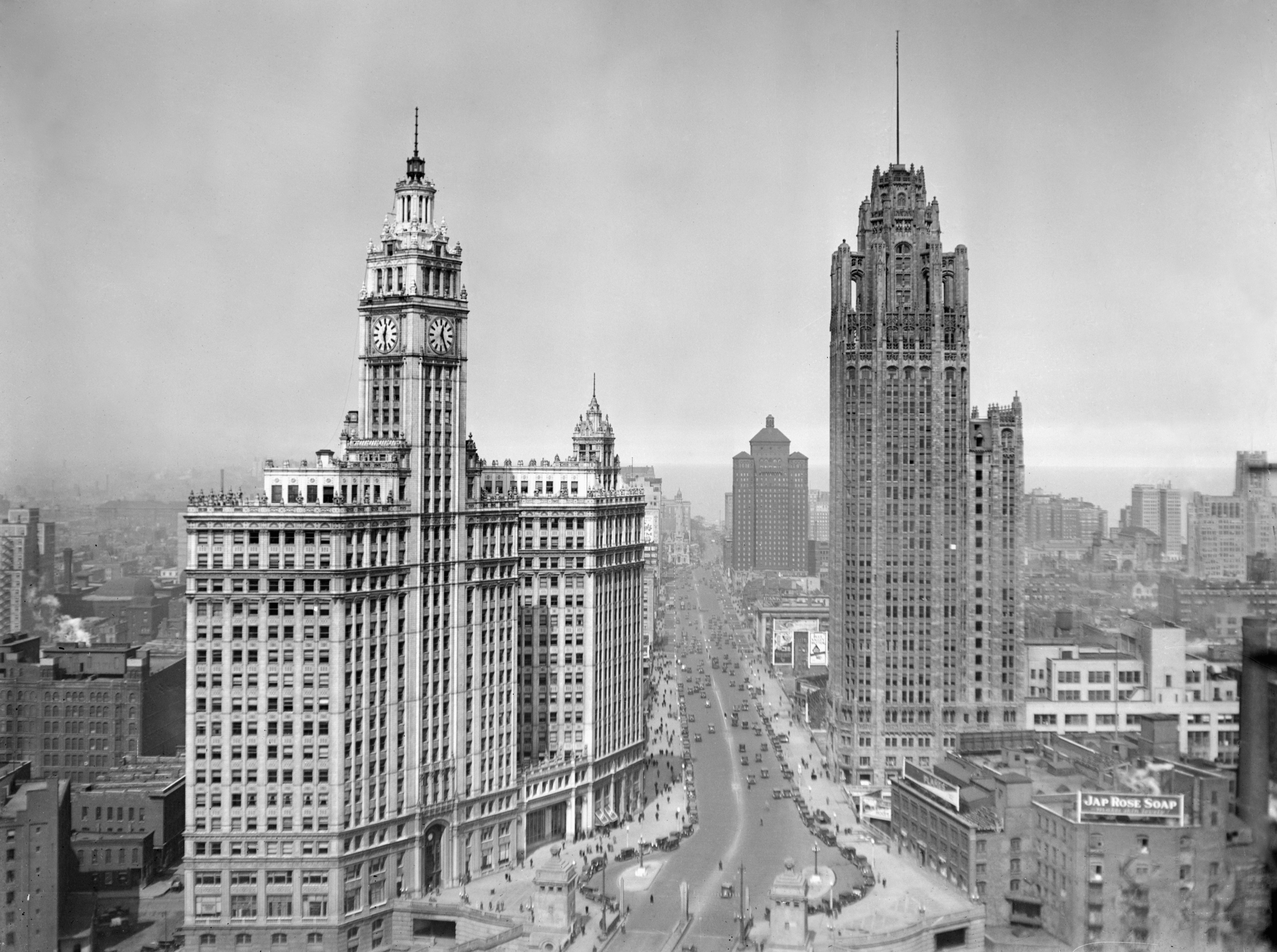 Photo of two buildings in the forefront with a lake in the background. 