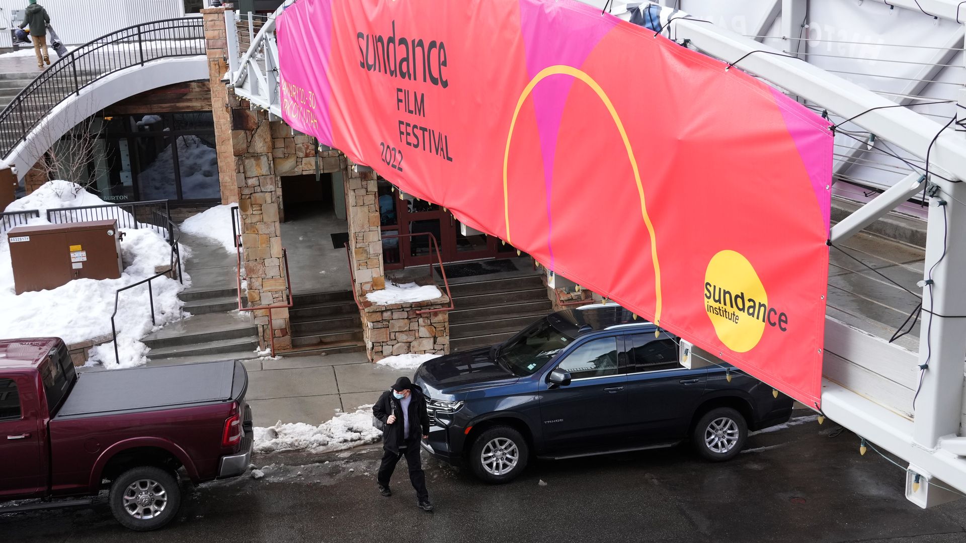 A pink banner reads "Sundance Film Festival" over a city street.