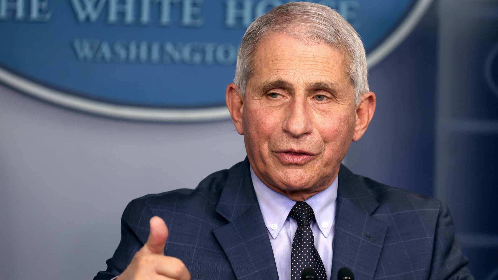Fauci stands behind the White House podium 