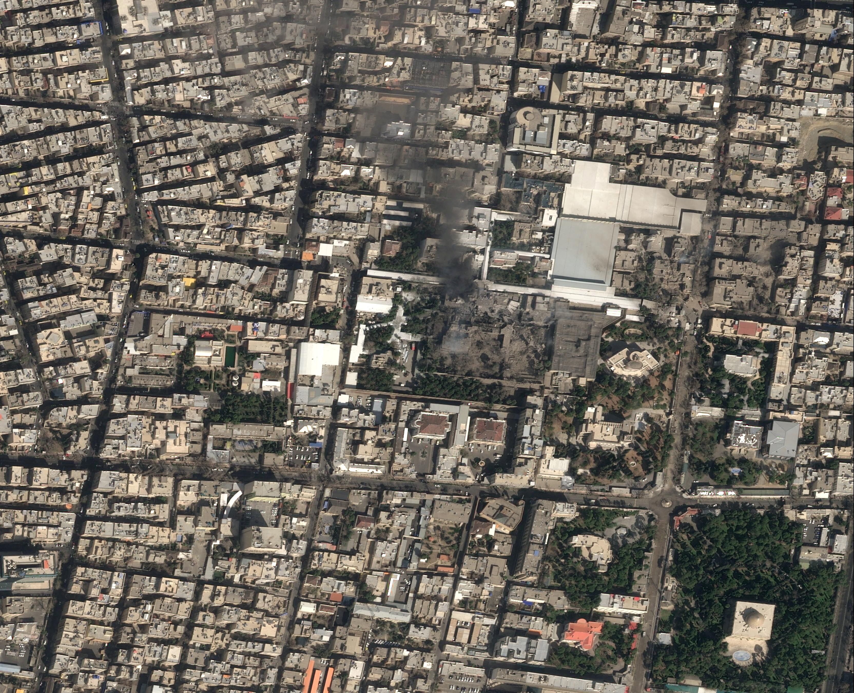 Black smoke rises today from Iran Supreme Leader Ali Khamenei's heavily damaged compound in Tehran. Satellite image: Pléiades Neo/Airbus via Reuters