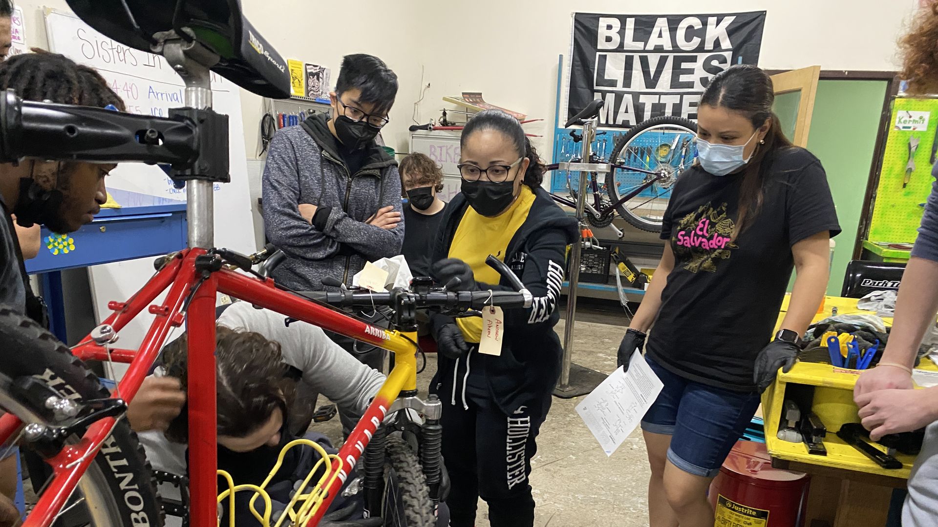 people work on bikes in a shop