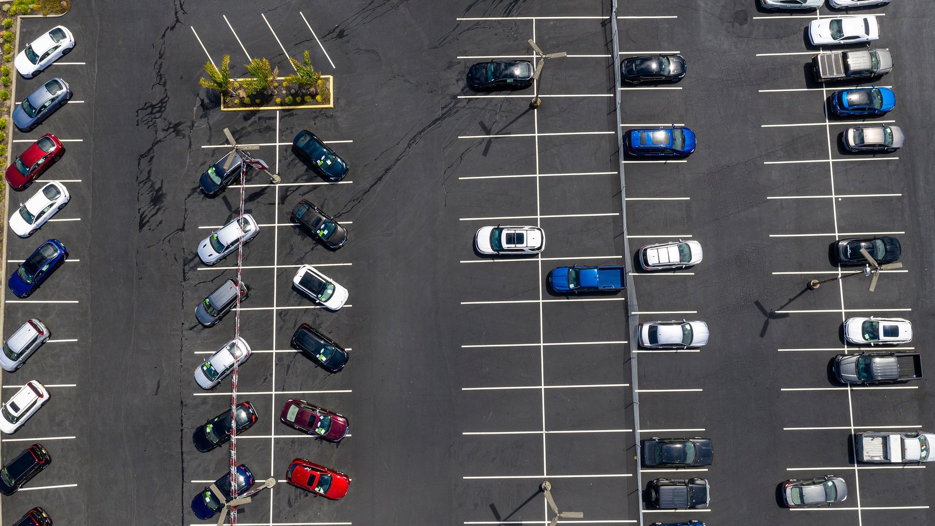 An aerial view of a mostly empty car lot 