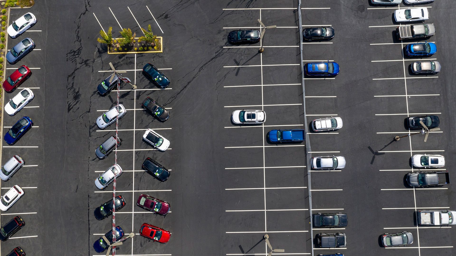 An aerial view of a mostly empty car lot