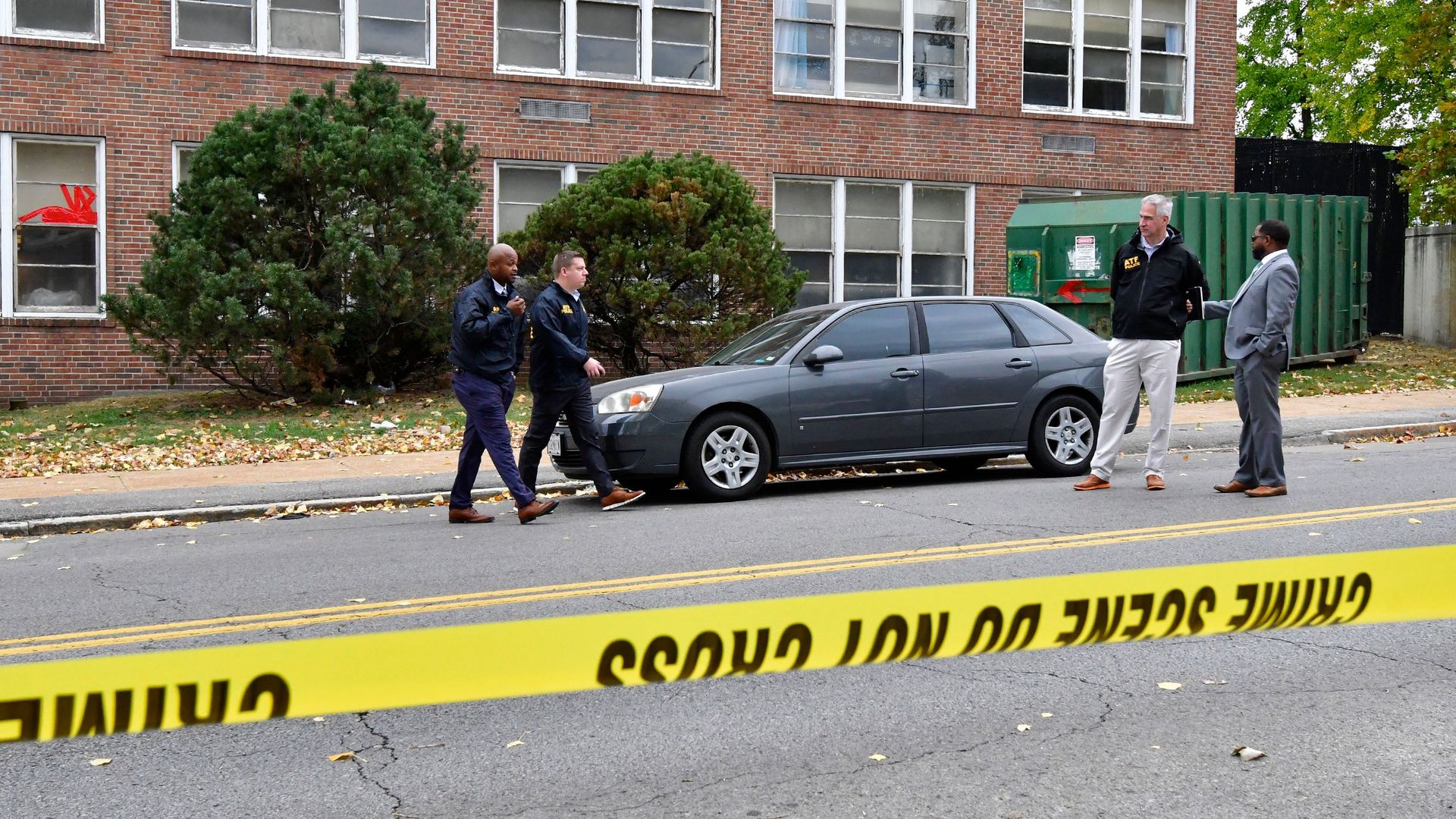 St. Louis Metropolitan police and Alcohol, Tobacco & Firearms officers stand outside the Central Visual and Performing Arts High School after a shooting.