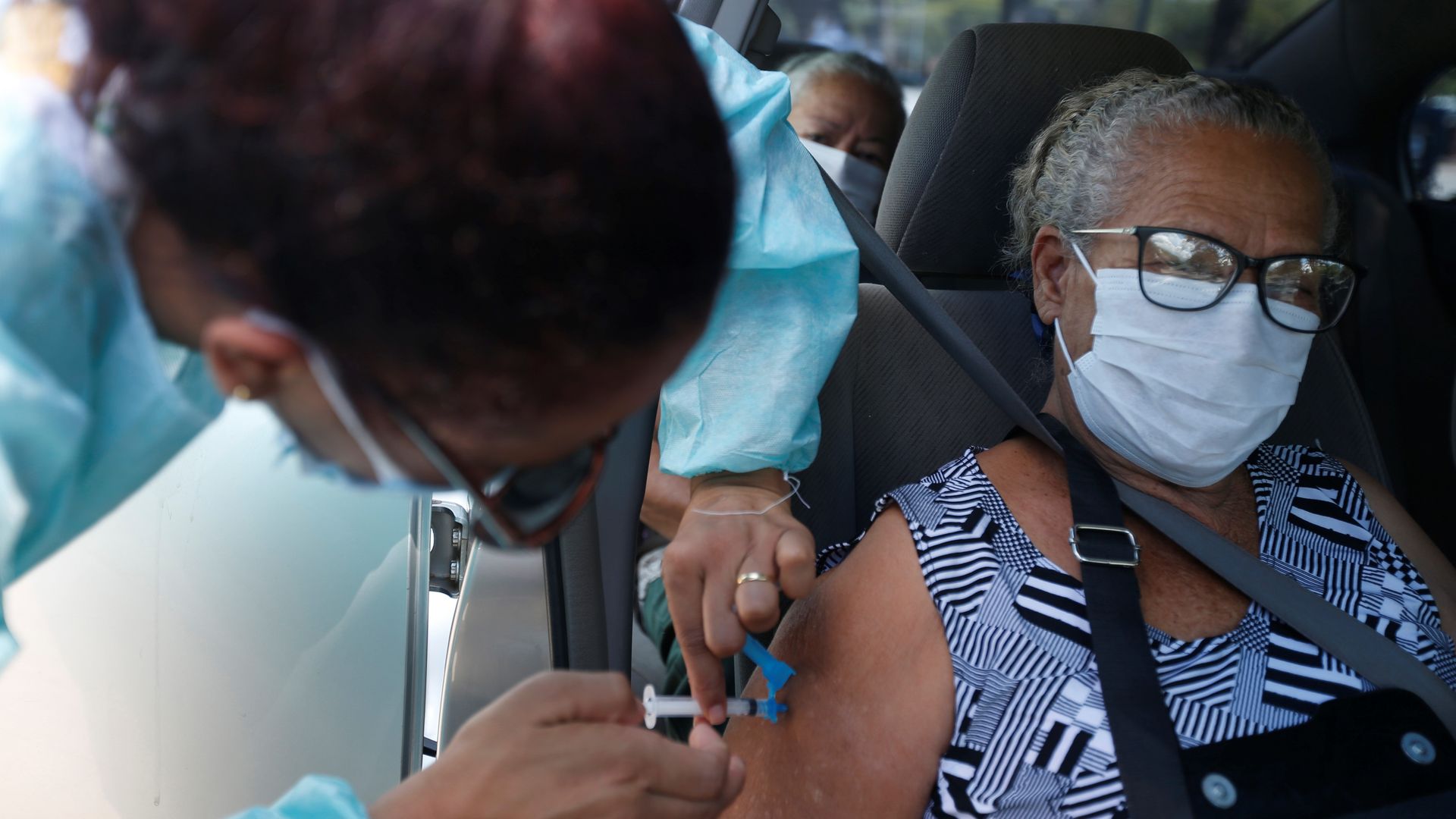 A health care worker administering a coronavirus vaccine in Brasilia, Brazil, Feb. 10.