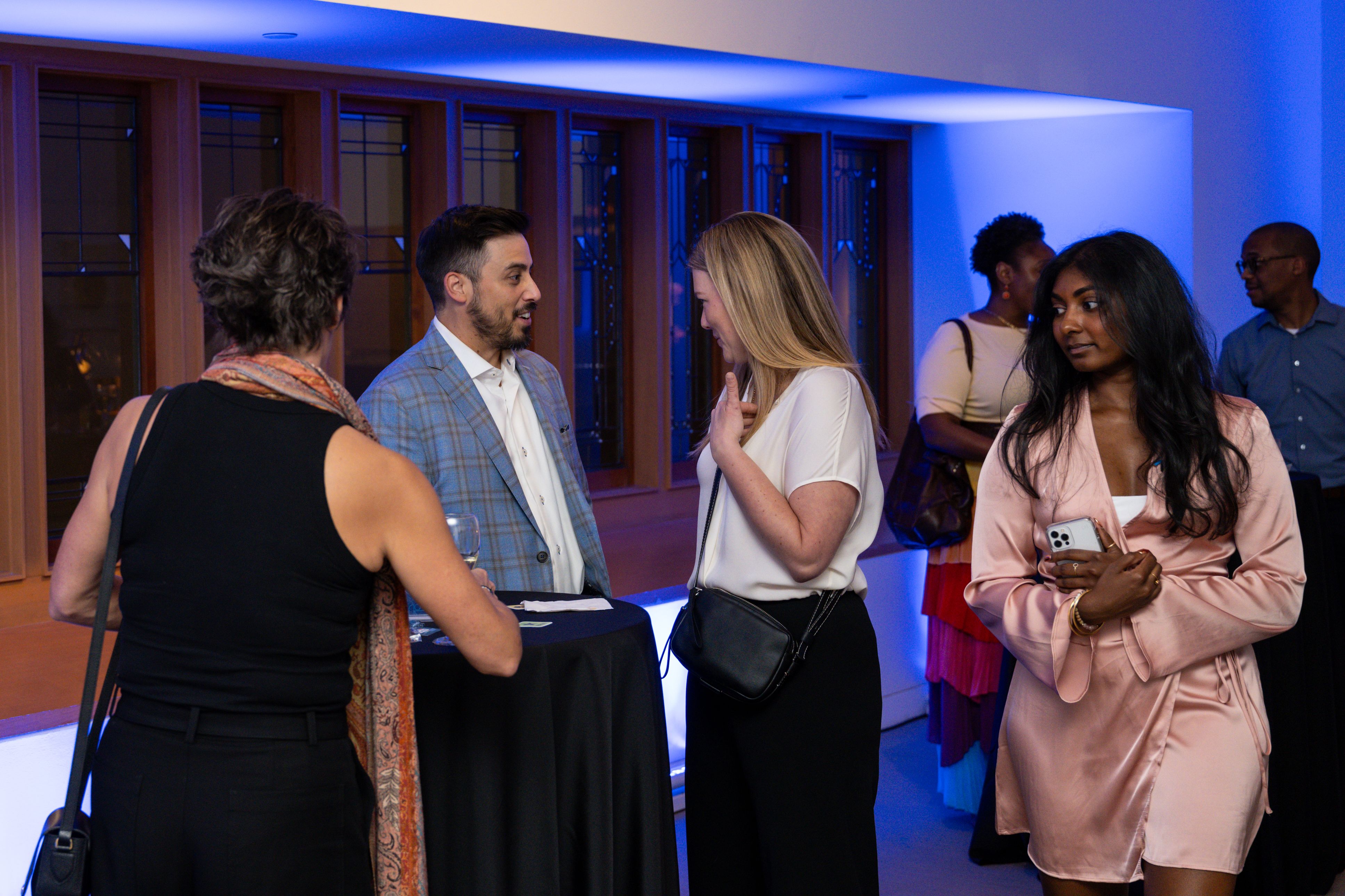 people stand talking at power players event