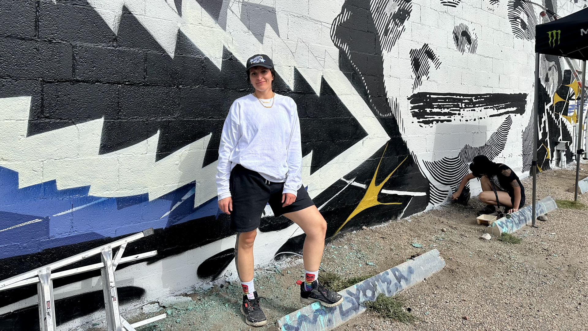 Denver Walls organizer Ally Grimes in front of a mural she's painting in RiNo with Sofia Ramirez of Loveland, right. Photo: John Frank/Axios
