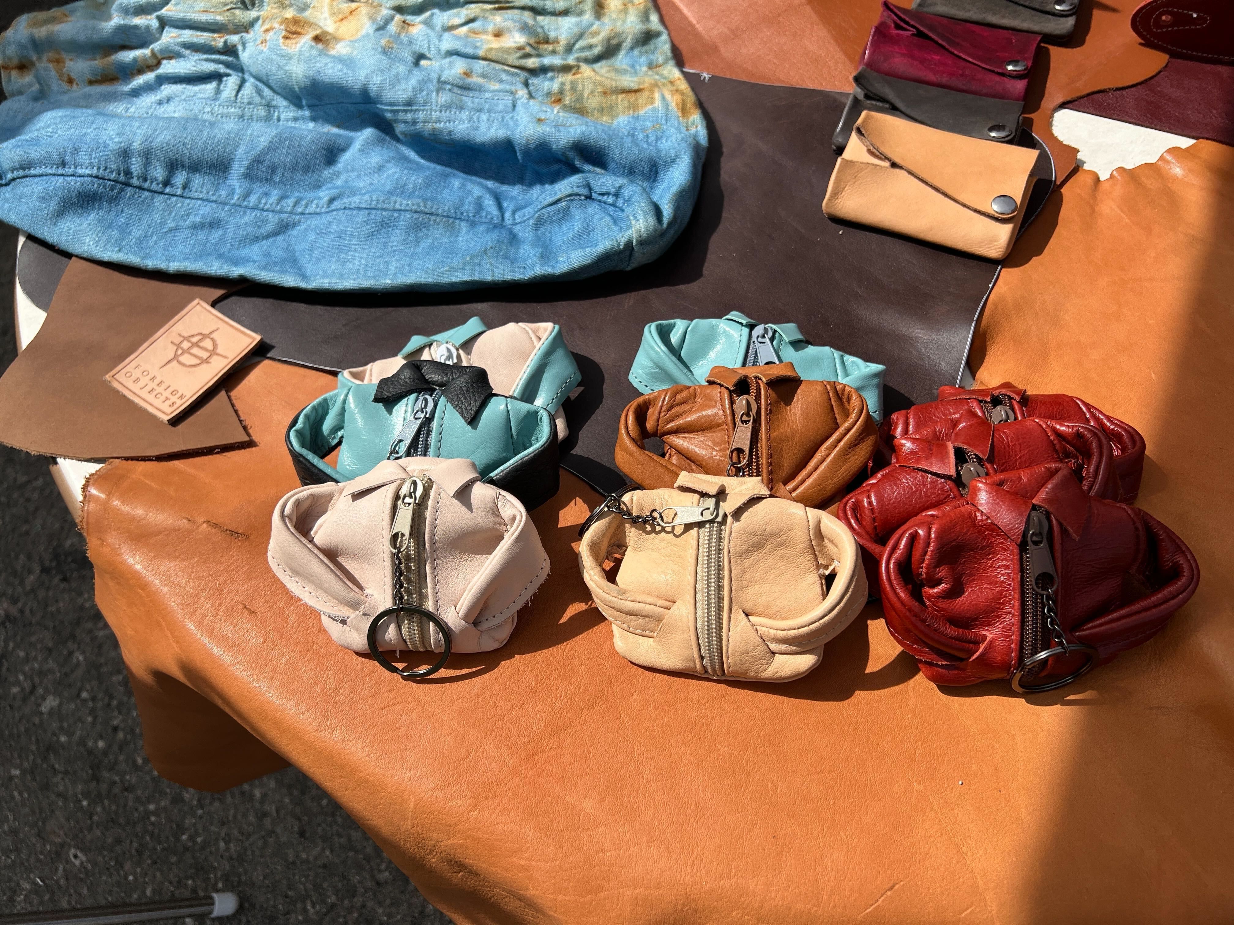 Tiny jacket coin purses made by Foreign Objects that are cut and sewn by hand in Detroit.