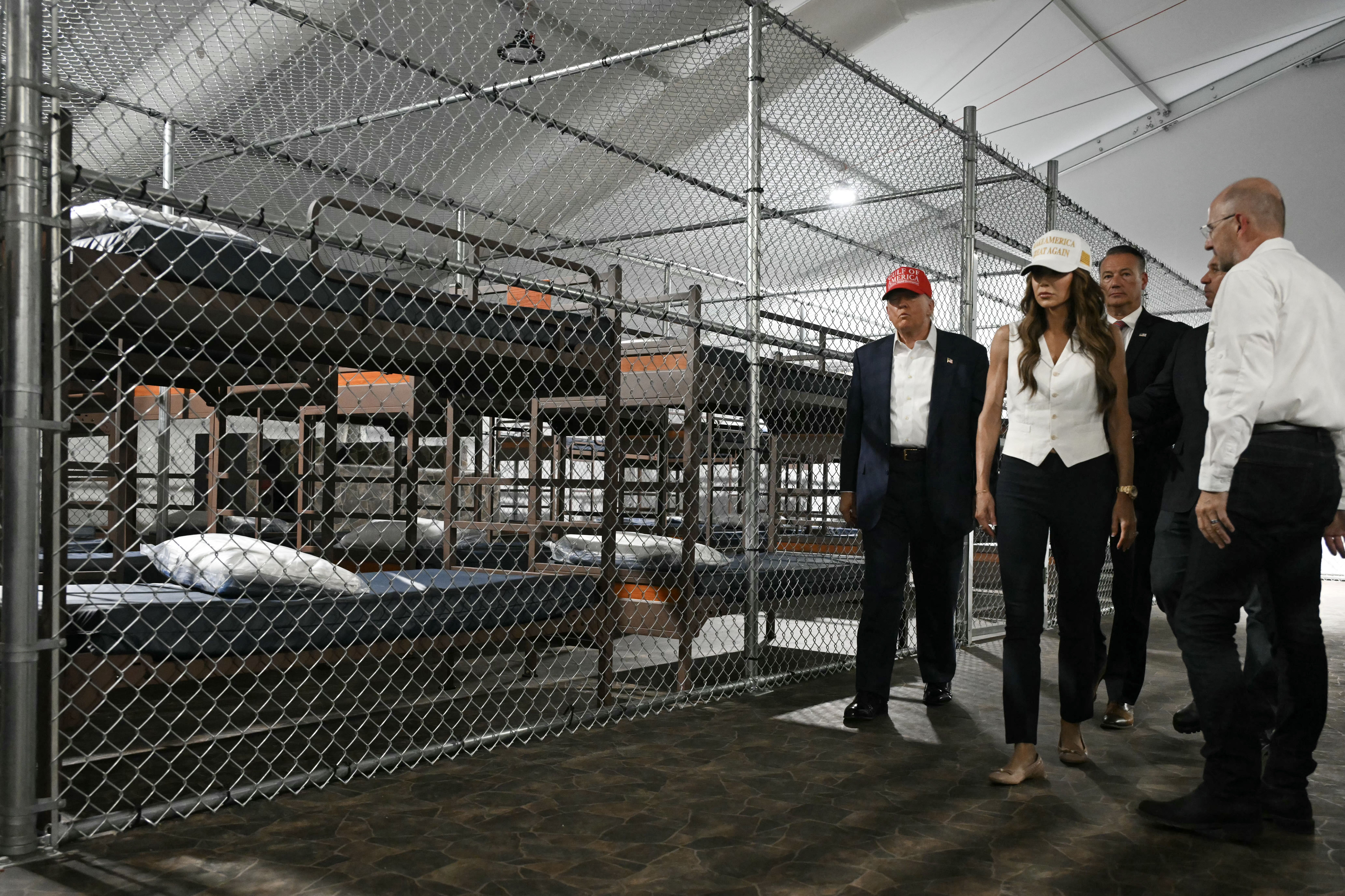 US President President Donald Trump (L), Florida Governor Ron DeSantis (2nd-R), and Secretary of Homeland Security Kristi Noem (2nd-L) tour a migrant detention center, dubbed "Alligator Alcatraz," located at the site of the Dade-Collier Training and Transition Airport in Ochopee, Florida on July 1, 