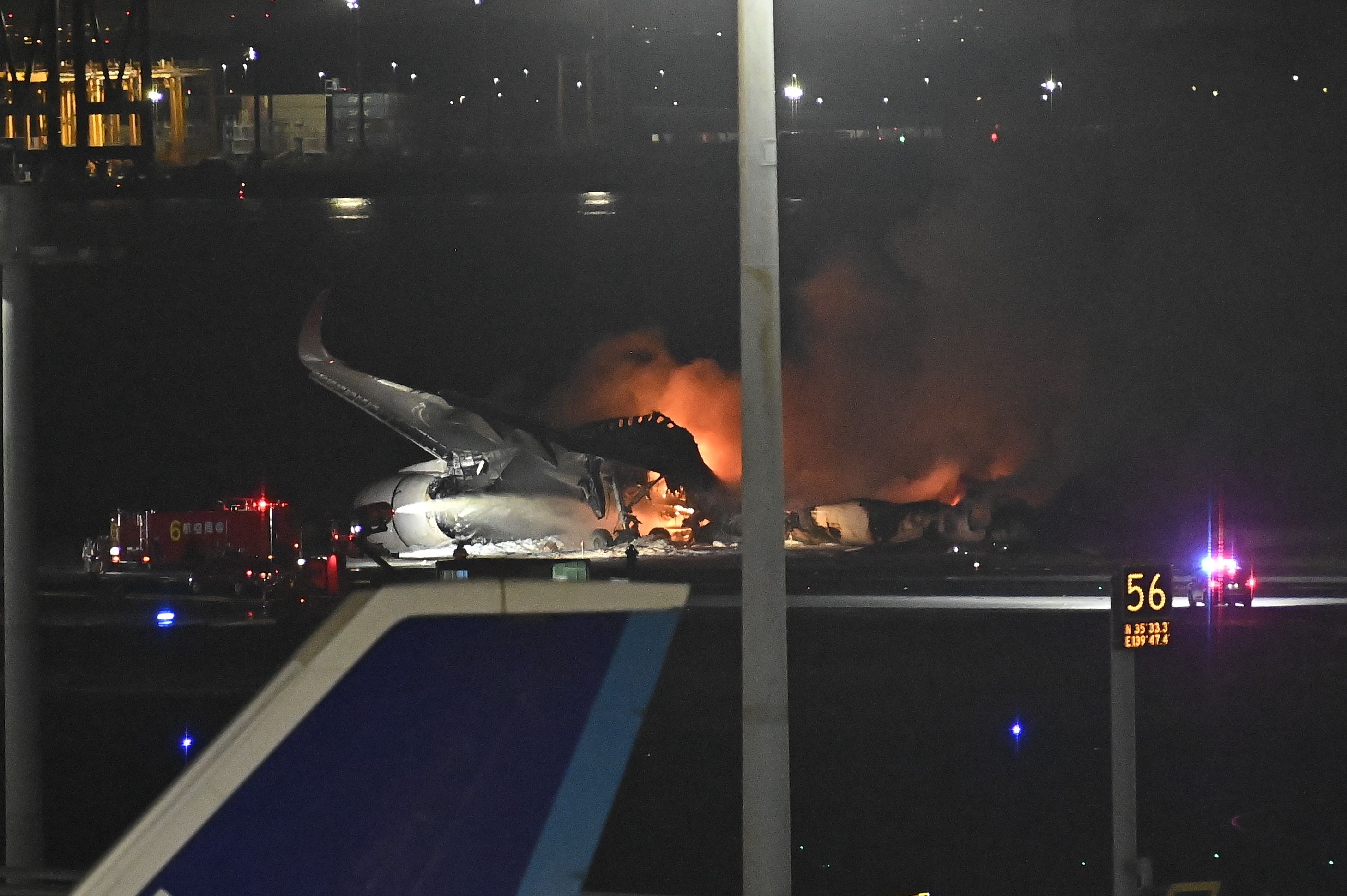 Japan Airlines flight burns on Tokyo tarmac as firefighters battle the blaze.