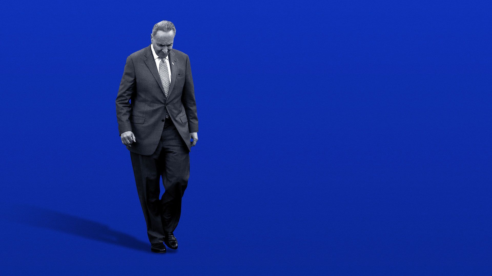 Illustration of Chuck Schumer looking down casting a long shadow