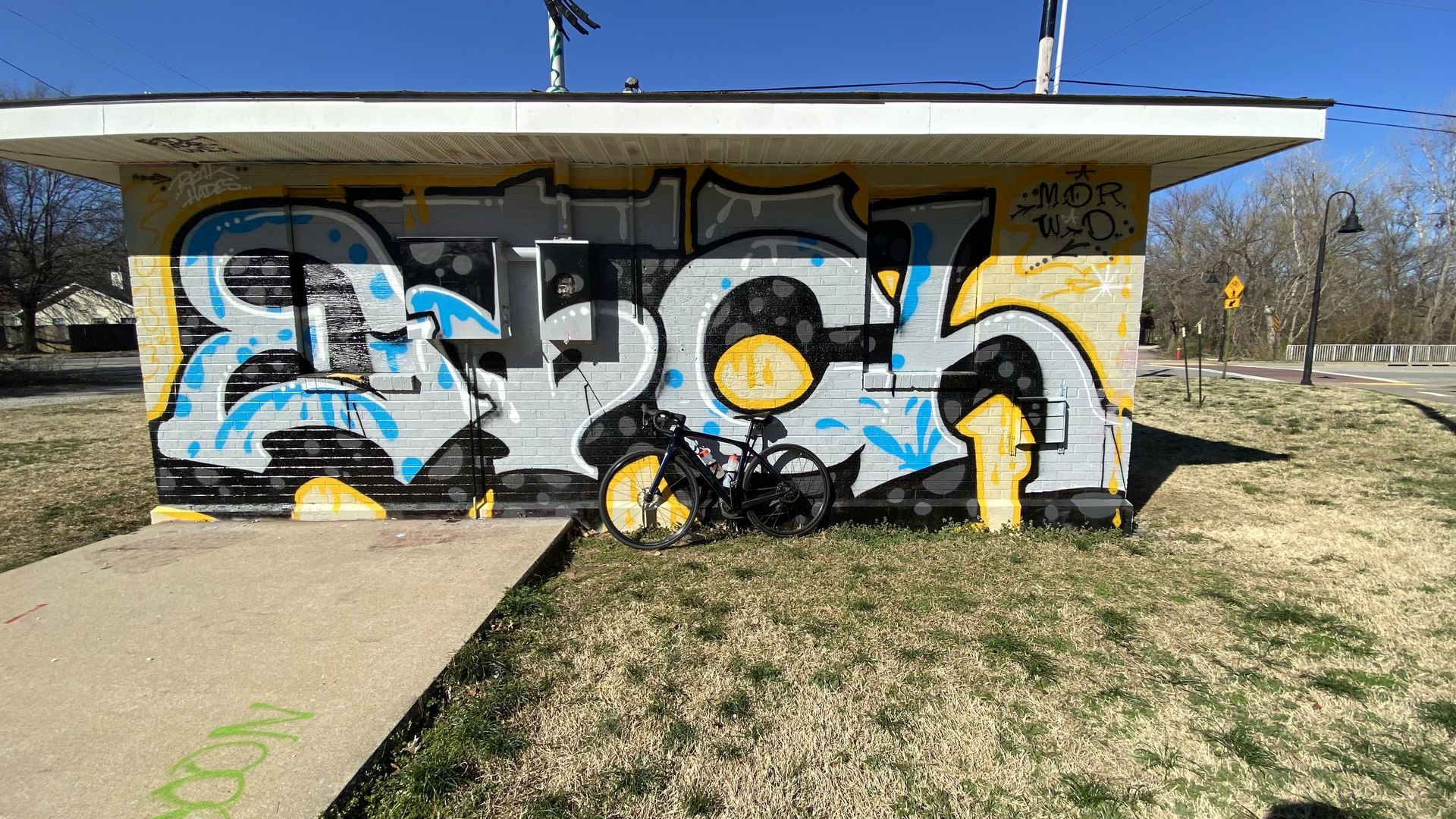 A photo of a mural of letters painted on a brick wall. 