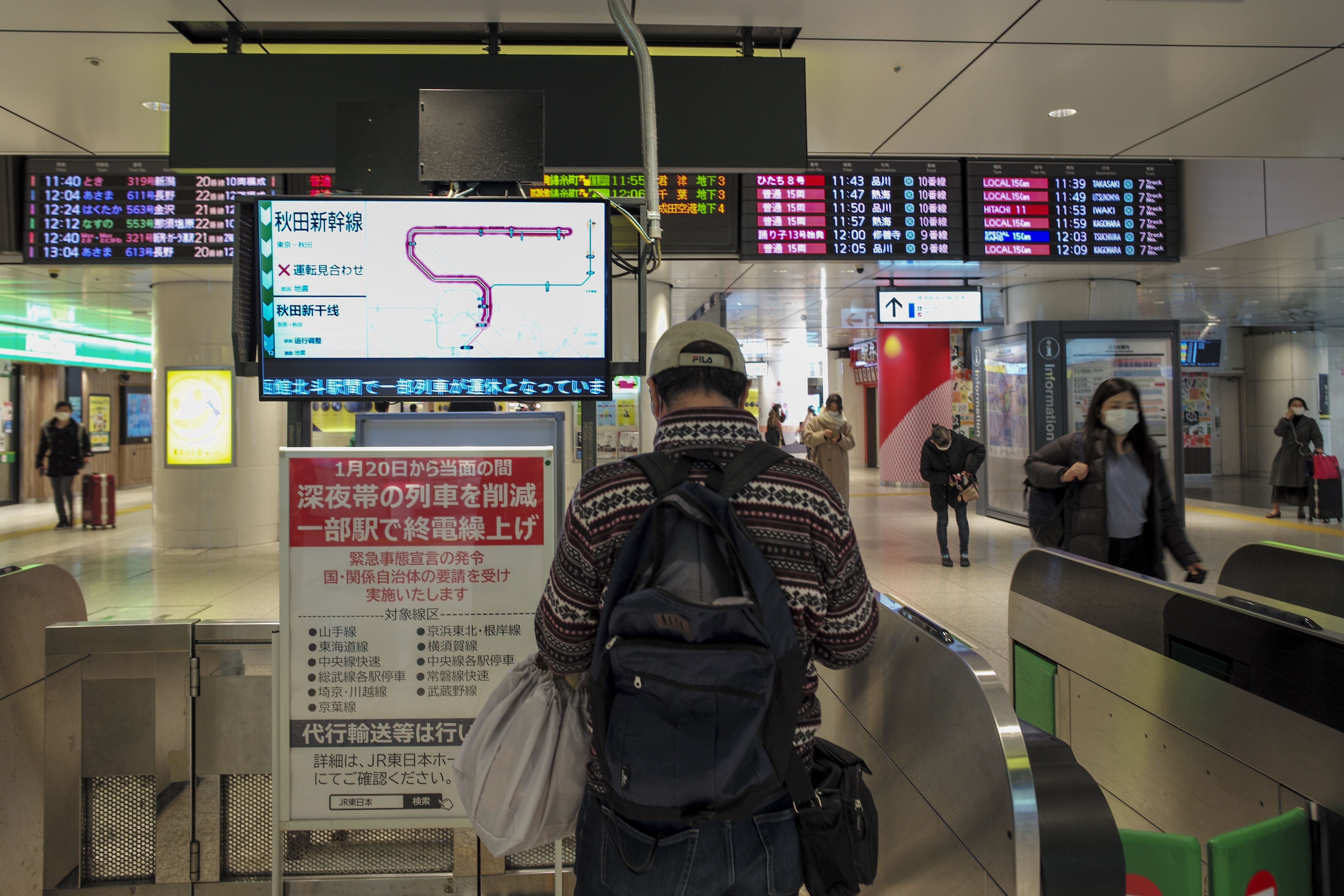 Screens display the suspenion of operations of the Shinkansen bullet train in the Tohoku region at JR Tokyo Station in Tokyo on February 14