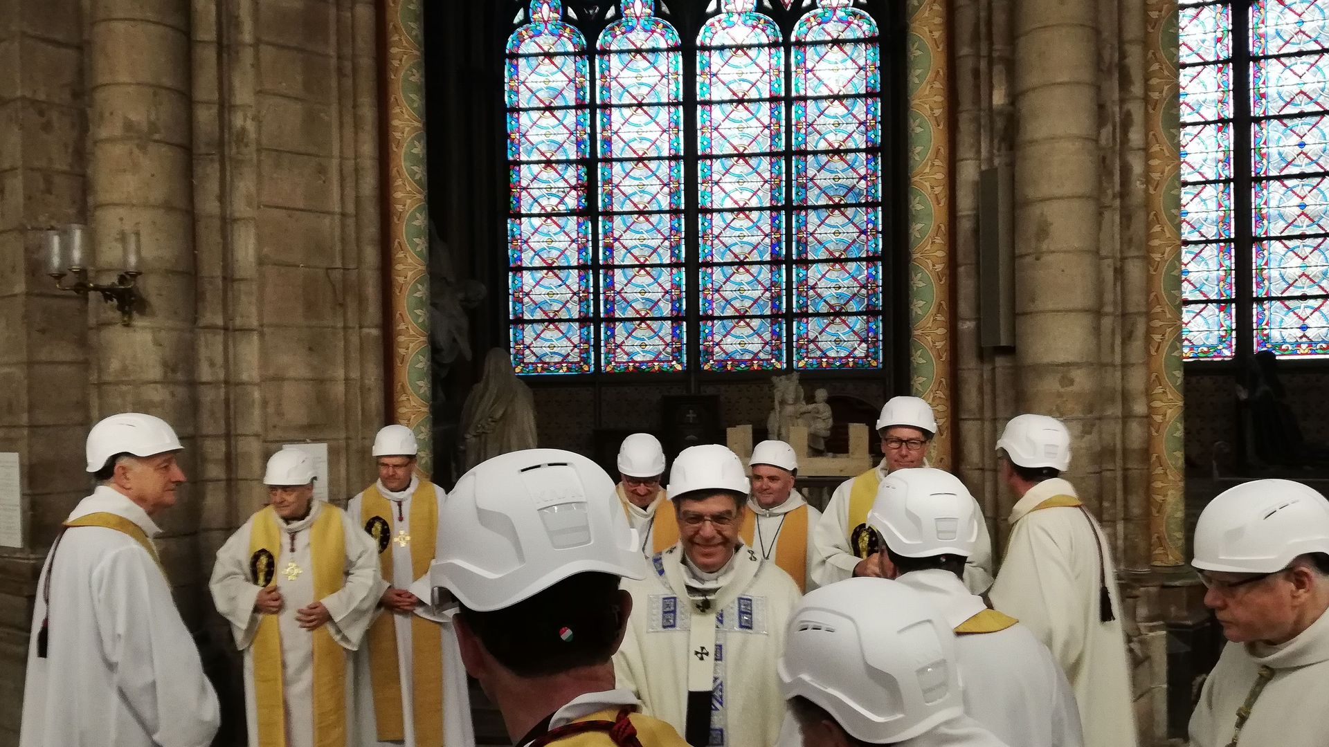 The Archbishop of Paris Michel Aupetit (C) greets other clergy following the first mass in a side chapel, after a fire engulfed the Notre-Dame de Paris cathedral, on June 15, 2019, in Paris.