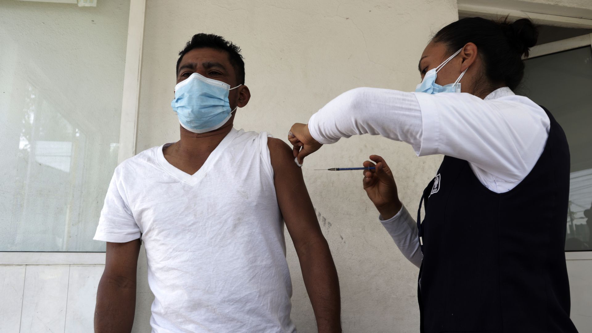 A migrant receives a vaccine dose in Mexico before continuing their journey to the U.S. border
