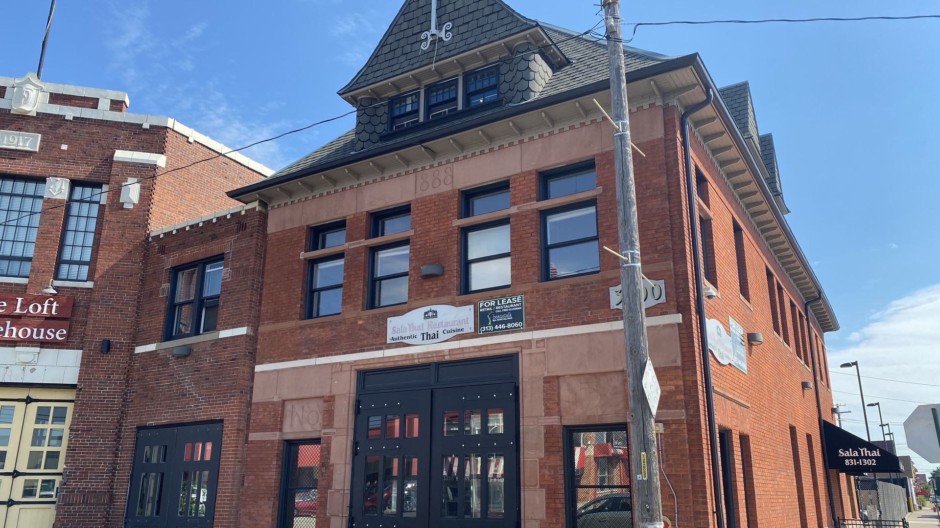 A brick firehouse building is shown with a "For Lease" sign.