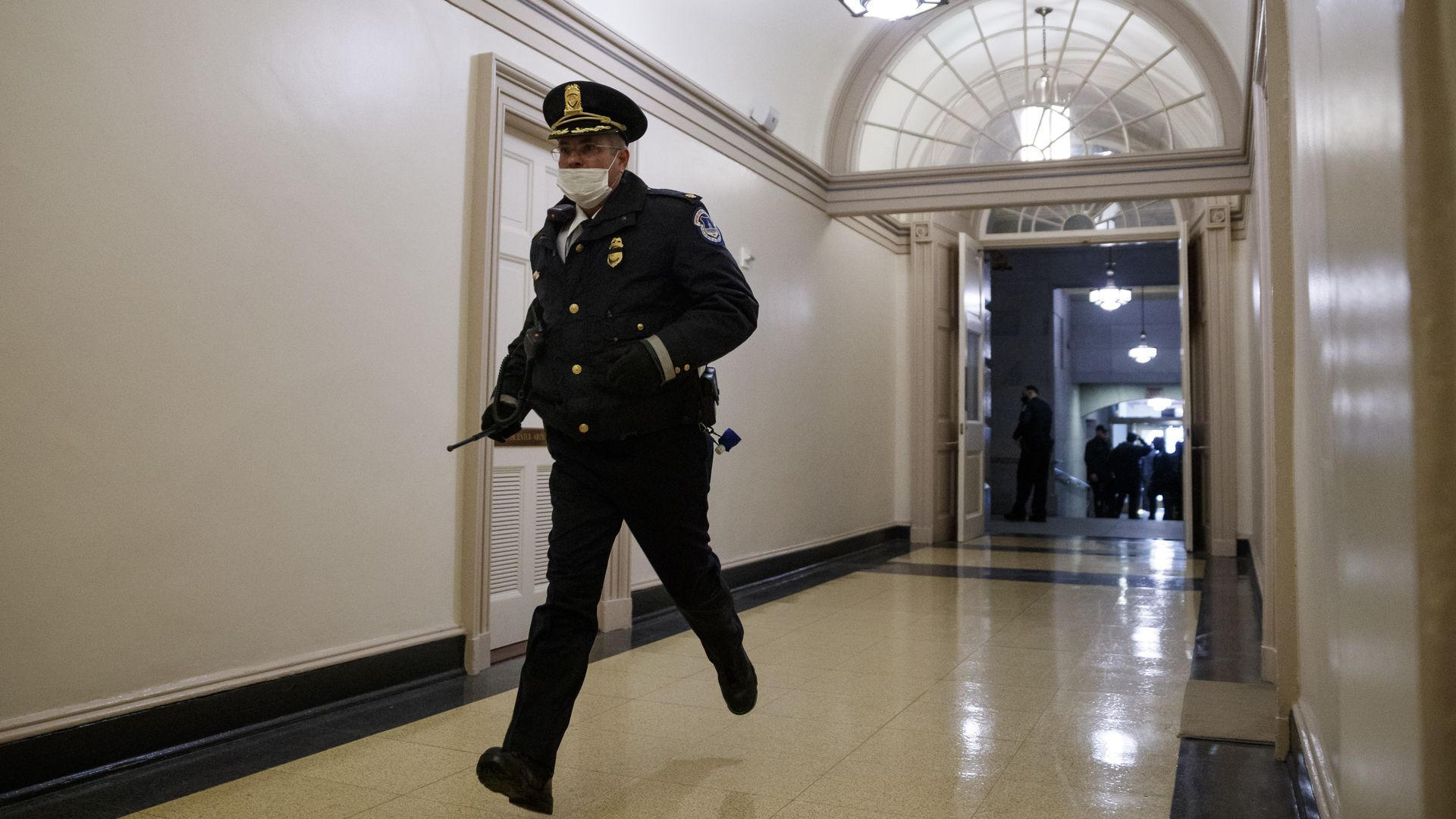A Capitol Police officer running through the U.S. Capitol while responding to the riot on Jan. 6.