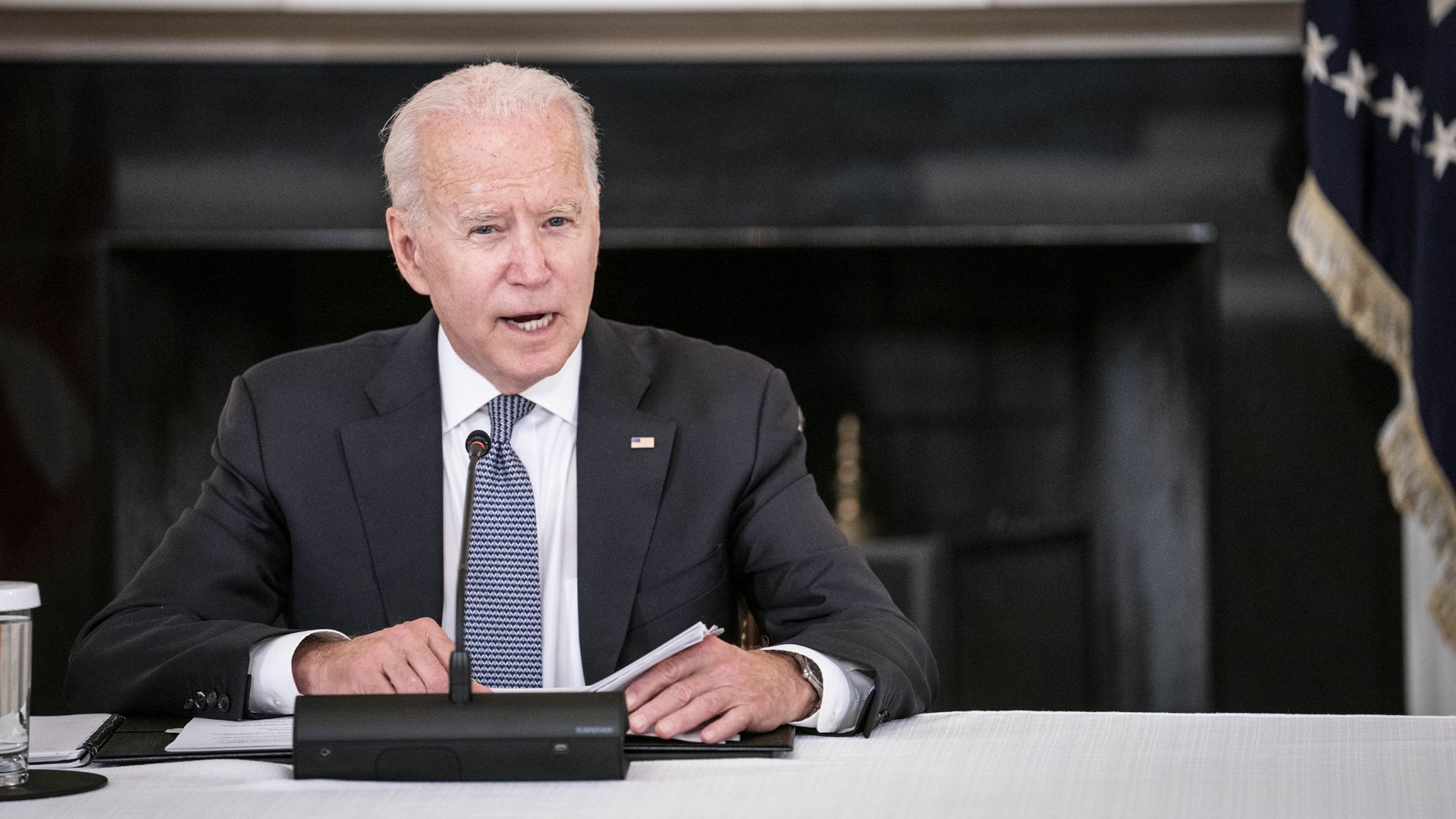 Photo of Joe Biden sitting at a table and speaking 