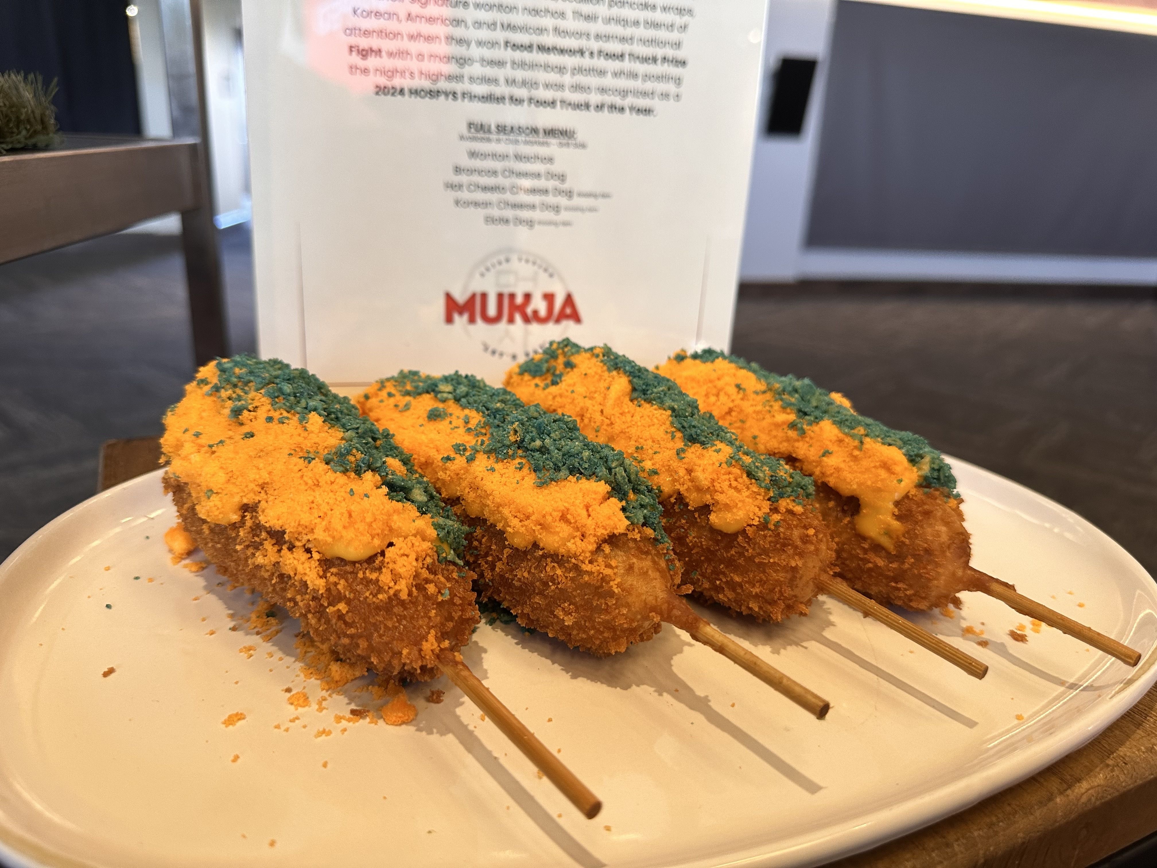 A photo of four fried and crispy-looking corn dog type things.