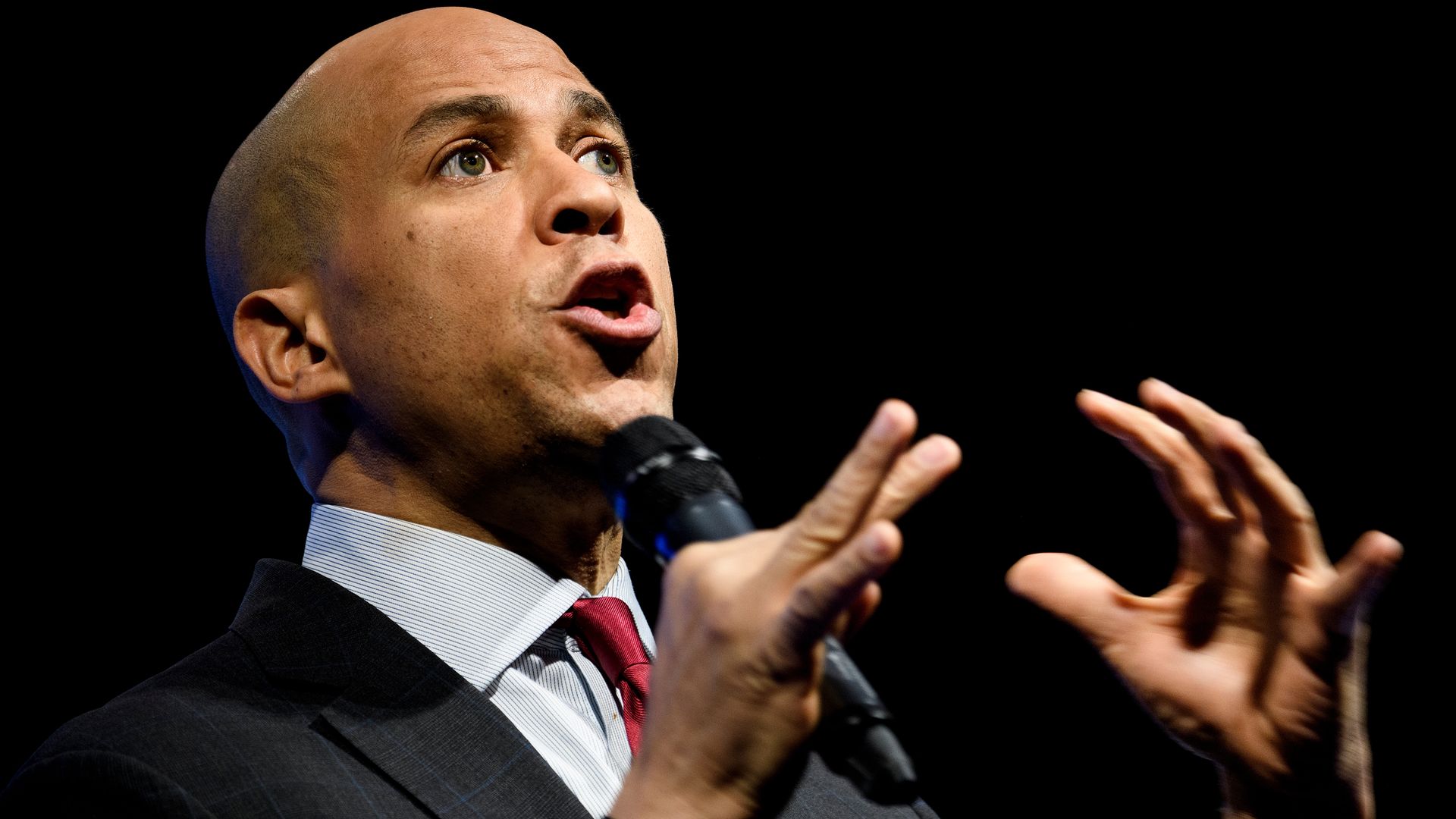 In this image, Cory Booker speaks into a microphone.