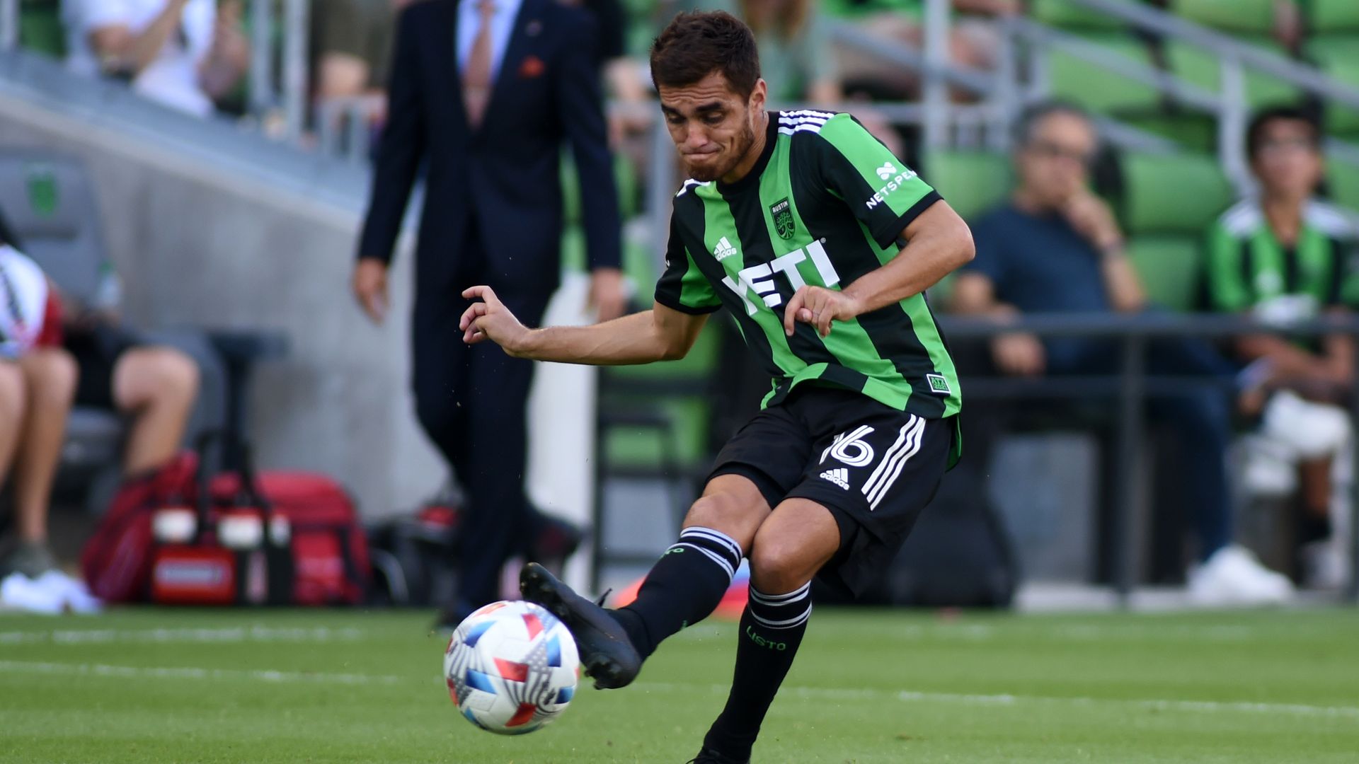 An Austin FC player kicks a soccer ball.