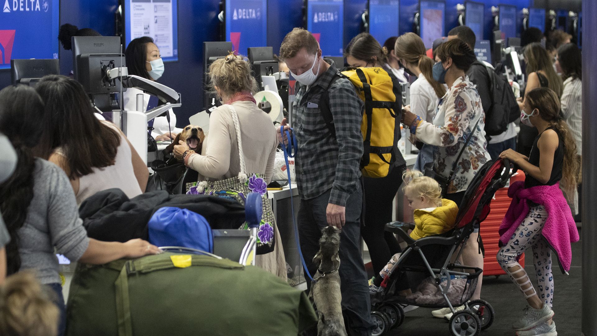 Image of crowded check-in with masked passengers at Los Angeles airport