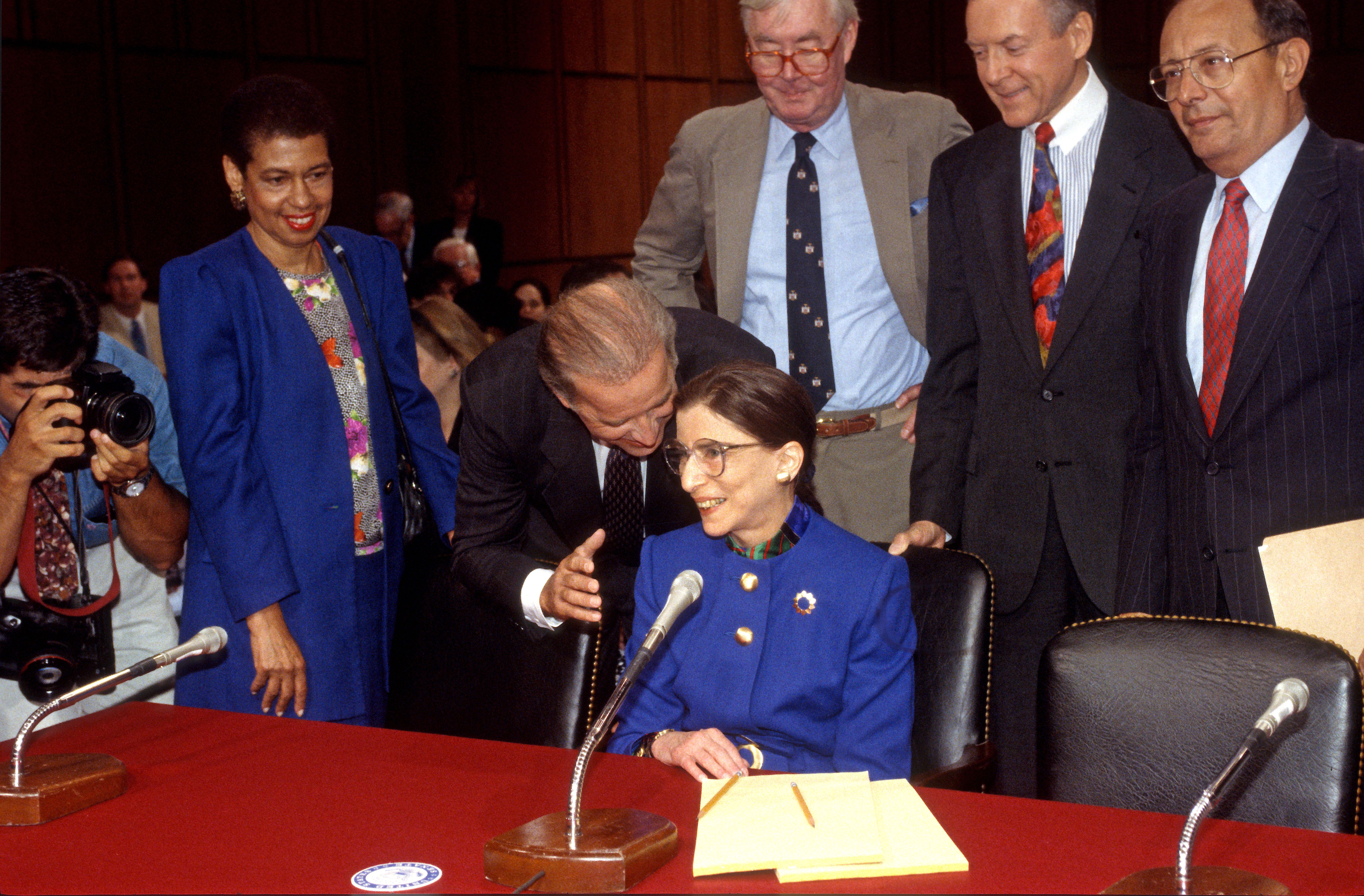 Senate Committee on the Judiciary Chairman US Senator (and future US President) Joe Biden (second left, leaning forward) speaks with US Court of Appeals (for the District of Columbia) Judge Ruth Bader Ginsburg (1933 - 2020) prior to the latter's Associate Justice of the Supreme Court confirmation.