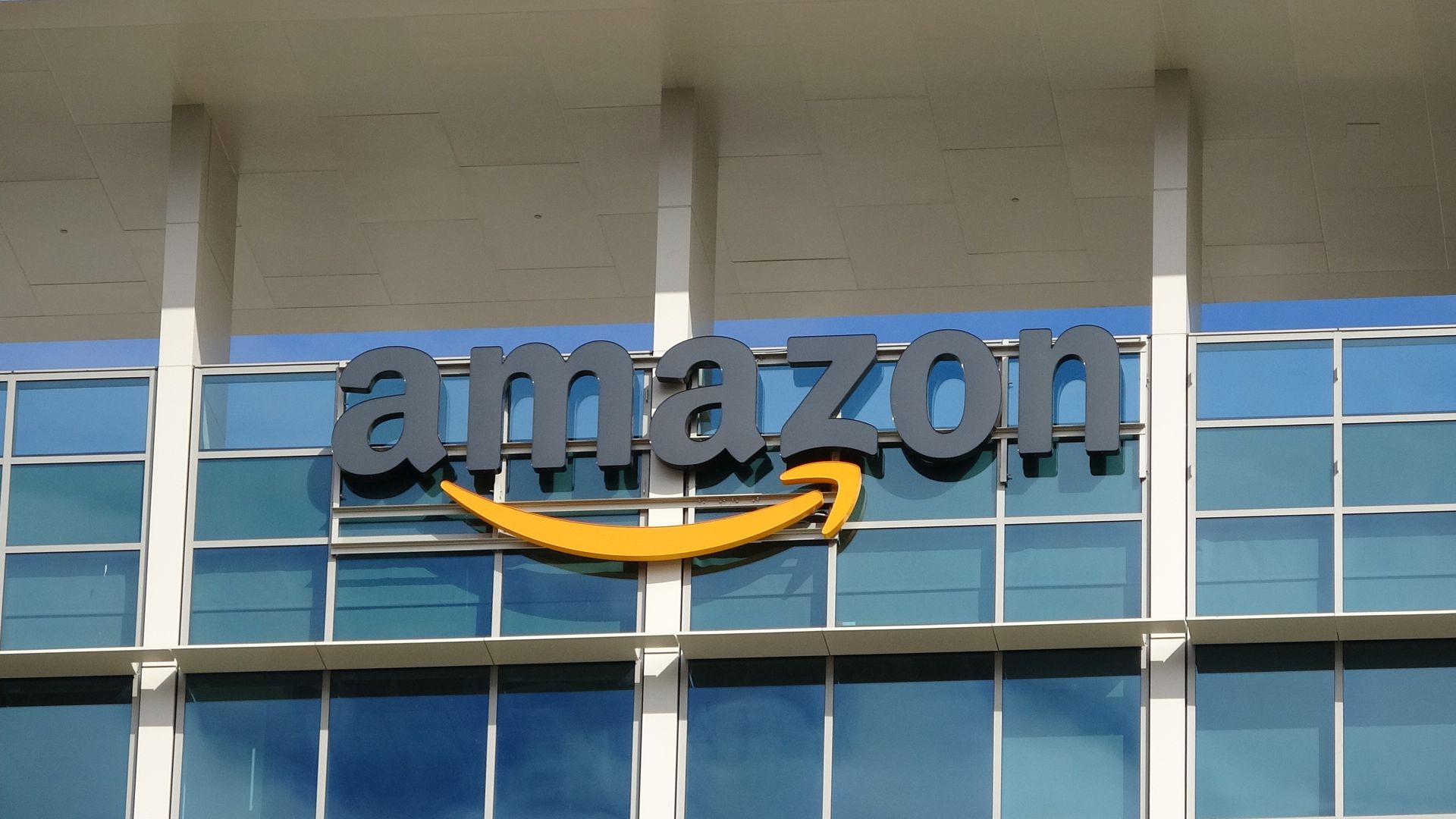Close-up of sign with logo on facade of the regional headquarters of ecommerce company Amazon in the Silicon Valley town of Sunnyvale, California.