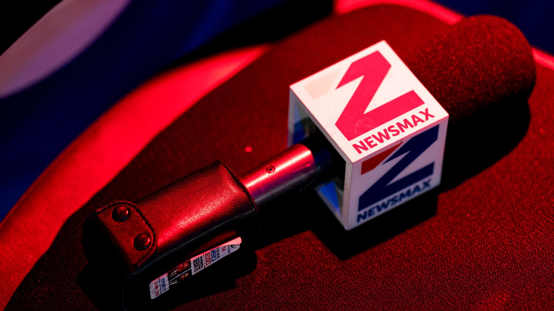 A Newsmax microphone bathed in red light sits in the spin room ahead of the first vice presidential debate at the CBS Broadcast Center in New York on Oct. 1, 2024. 