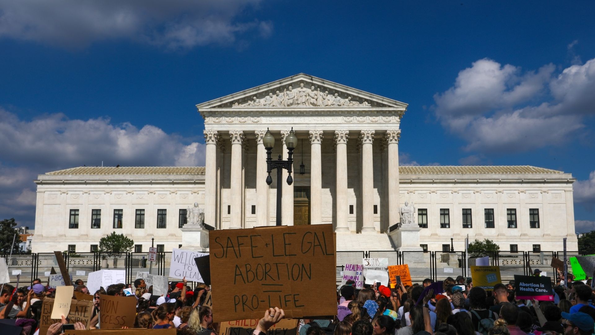 A demonstrator holds a sign outside of the Supreme Court building